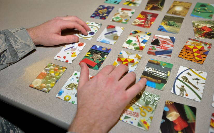 ELMENDORF AIR FORCE BASE, Alaska -- A patient in the Traumatic Brain Injury clinic plays a game of "I Spy" to help with cognitive functions they he may have lost after receiving a brain injury Nov. 18. Simple games are played so patients can build the skills they may have lost to determine whether they are suited to go back to work be medically discharged. (U.S. Air Force photo/Senior Airman Tinese Treadwell)