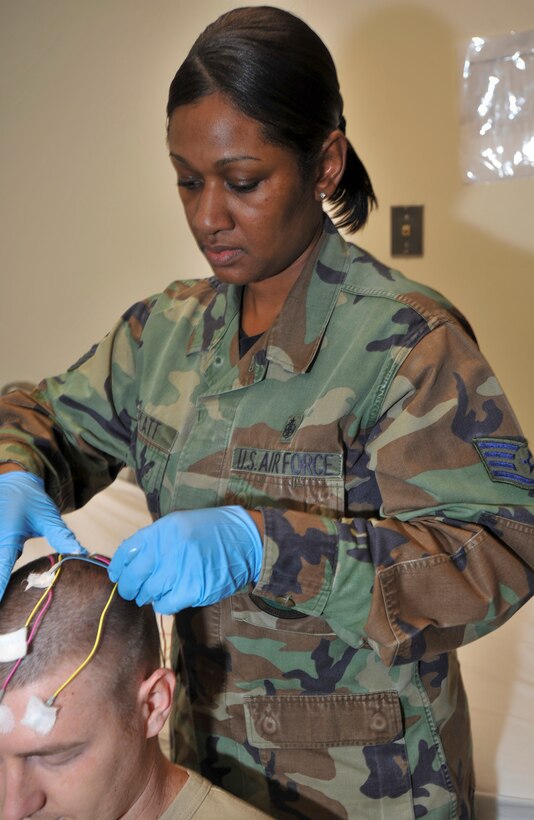ELMENDORF AIR FORCE BASE, Alaska -- Tech. Sgt. Valarie Platt preps a patient for an electroencephalography scan in the Traumatic Brain Injury clinic Nov. 18. The electroencephalogram records brain activity to rule out different things like seizures that are accompanied by TBI. (U.S. Air Force photo/Senior Airman Tinese Treadwell)