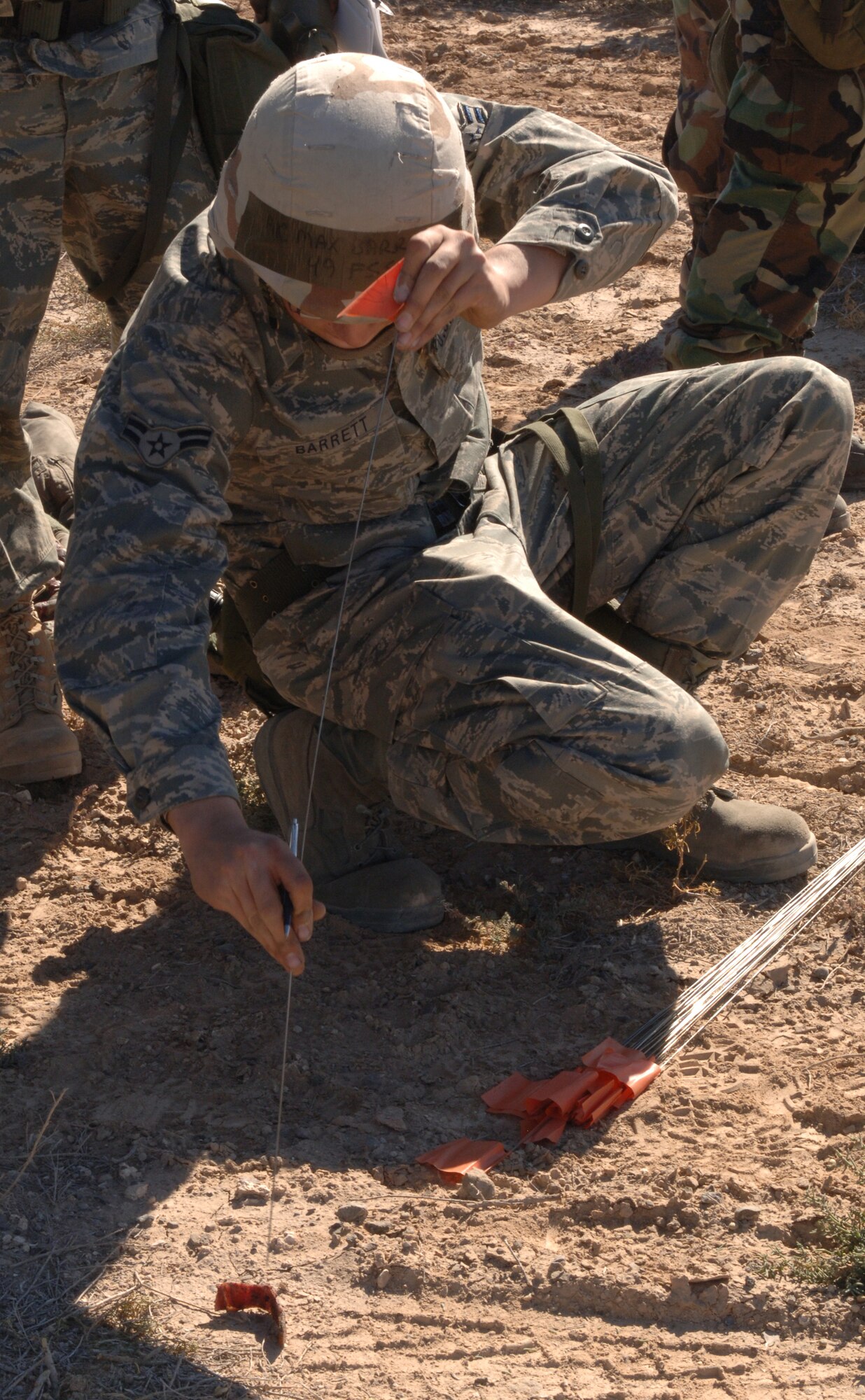 Airman 1st Class Max Barrett, 49th Force Support Squadron, participates in a search and recovery scenario at Holloman Air Force Base, N.M., Nov. 20. Airman Barrett's role is to mark the locations of all the remains and personal items found. Approximately 30 members from the 49th Fighter Wing were called to perform the simulated search and recovery during Exercise Coronet Gold Rush 08-08. (U.S. Air Force photo/Airman 1st Class Michael Means)