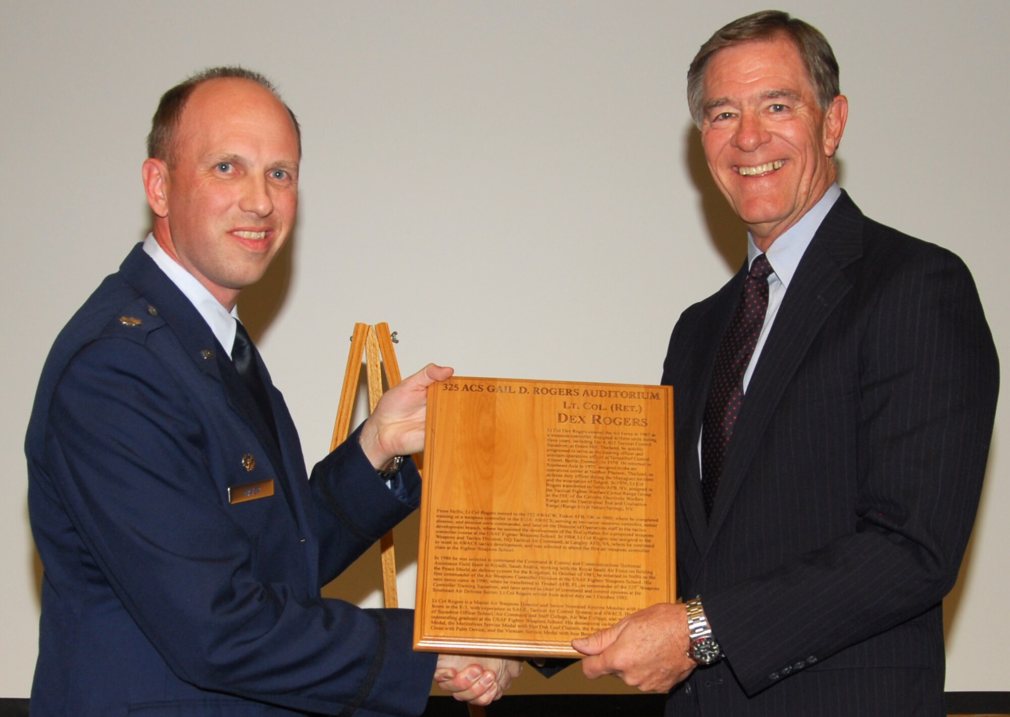 Lt. Col. Charles Mayer, 325th Air Control Squadron commander, honors (ret.) Lt. Col. Gail Rogers with an auditorium dedication Tuesday.  Lt. Col. Rogers served as the 325th Weapons Controller Training Squadron commander at Tyndall in 1990.  (U.S. Air Force photo by Susan Trahan)