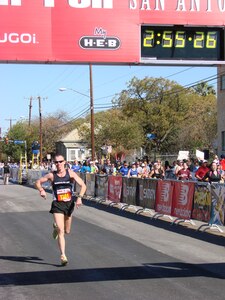 James Boddy, a major with the 19th Air Force, crosses the finish line at Sunday’s Rock and Roll Marathon-San Antonio with a time of 2:55:19. Boddy was Randolph’s top finisher and helped the base team finish second in the inaugural USAA Military Base Challenge. In addition to individual trophies, the 12th Services Squadron received a $1,500 check from USAA. (Photo by John Hancock)