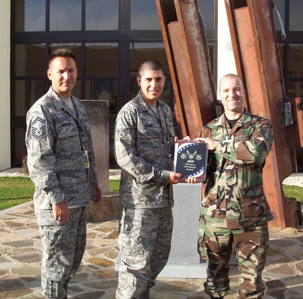 TYNDALL AIR FORCE BASE, N.D. -- Senior Airman Calvin Brown (center), an Airman from the 91st Missile Maintenance Squadron currently deployed to Tyndall AFB, Fla., is presented the newly created "AEF Making a Difference Award" here recently by fellow Air Expeditionary Force deployers Senior Master Sgt. Brian Bischoff (left) and Staff Sgt. Richard Linde. Airman Brown was recognized for working tirelessly to become station qualified in record time while providing outstanding support and mentorship to other AEF members.  He was also recognized by Col. David Kriner, 601st Air Operations Center commander, as being an "Outstanding Contributor" during the unit's recent unit compliance imspection.  Airman Brown was also cited as giving something back to the local community by dedicating part of his off-duty time for a local beach clean-up program.  Sergeant Bischoff created this award to recognize the efforts of AEF members deployed to Tyndall AFB who go above and beyond in their efforts. (Courtesy graphic)
