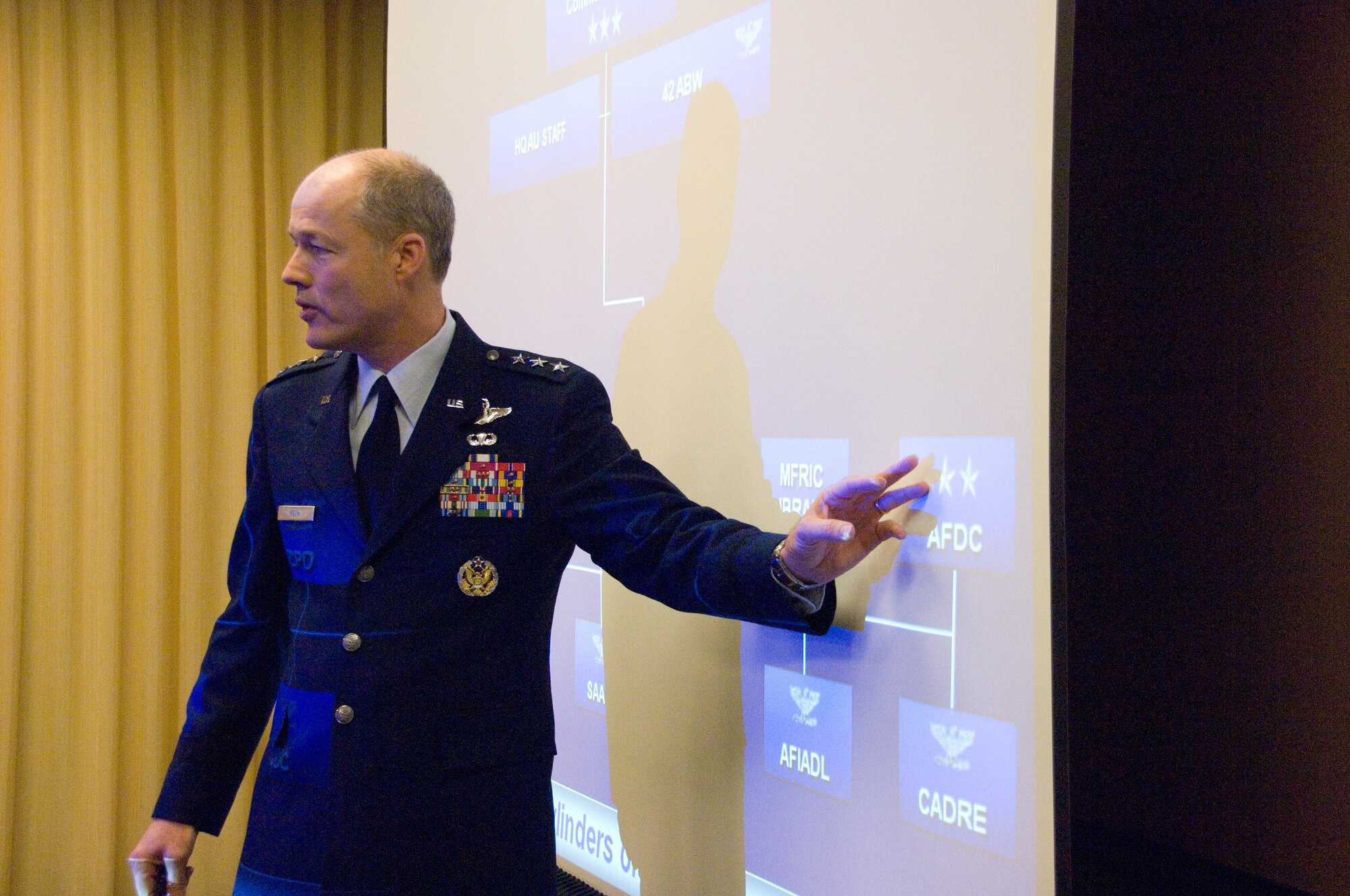 Lt. Gen. Allen Peck, Air University commander, explains the structure of the university to the AU Board of Visitors during a Tuesday breakfast meeting in downtown Montgomery. (Air Force photo by Melanie Rodgers)