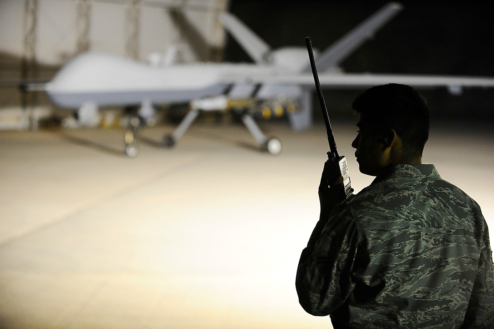 Airman 1st Class Hugo Garnica communicates with an MQ-9 Reaper pilot with a land mobile radio at Joint Base Balad, Iraq, Nov. 18. He was performing a pre-flight check to ensure the unmanned aircraft vehicle was operational. Garnica, an assistant dedicated crew chief assigned to the 332nd Expeditionary Aircraft Maintenance Squadron, is deployed from Creech Air Force Base, Nev. His hometown is Oceanside, Calif. (U.S. Air Force photo/Airman 1st Class Jason Epley)