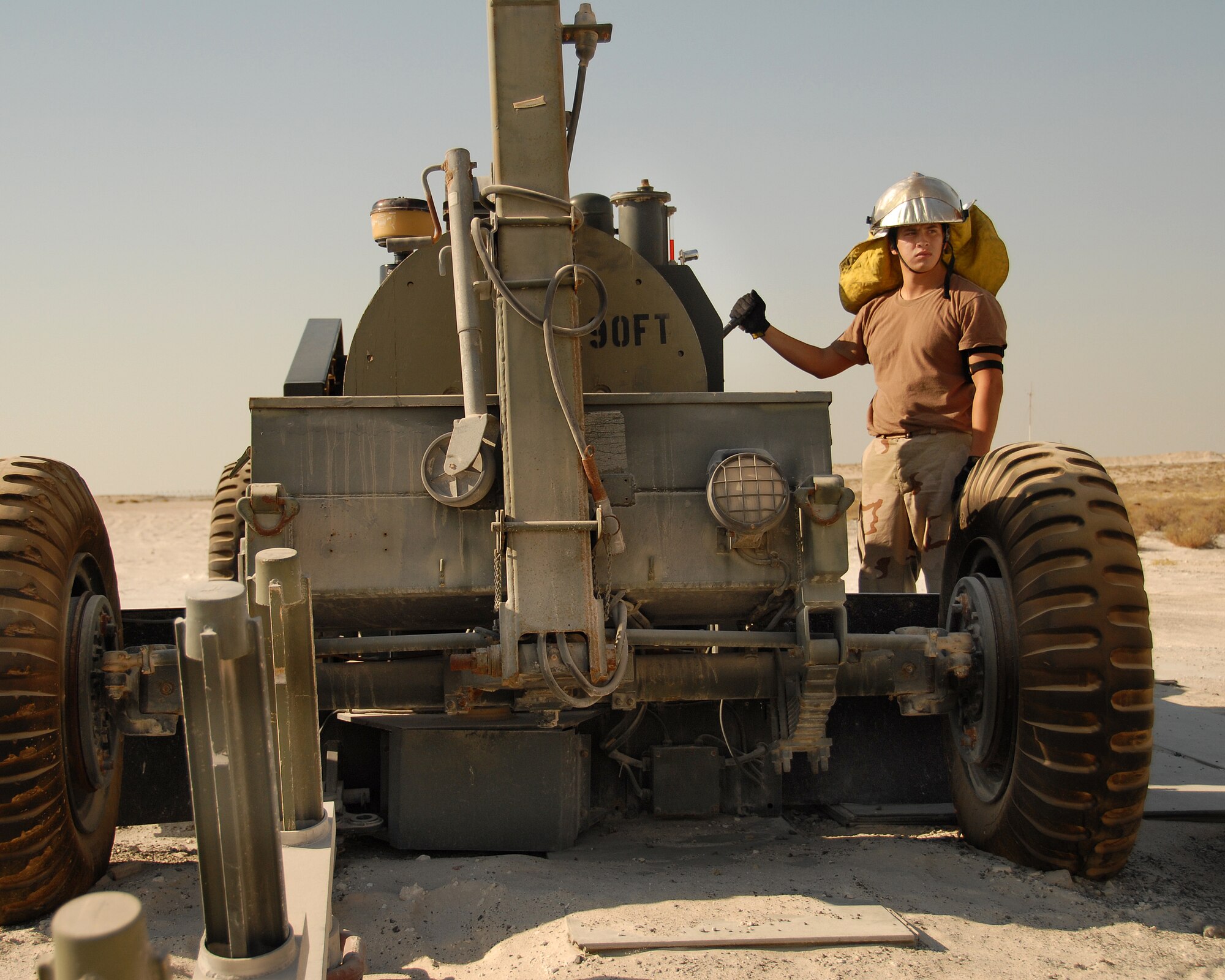 SOUTHWEST ASIA -- The 380th Expeditionary Civil Engineer Squadron's Airman 1st Class Tomas Rodriguez awaits Mobile Aircraft Arresting System-rewind commands from the point man near the runway here Nov. 19. Airman Rodriguez, deployed from 2nd CES at Barksdale Air Force Base, Calif., calls Craftsbury, Vt., home. Airman Rodriguez assisted in a cable engagement certification with the help of visiting F-15s from Eglin AFB, Fla. (U.S. Air Force photo by Tech. Sgt. Denise Johnson) (released)