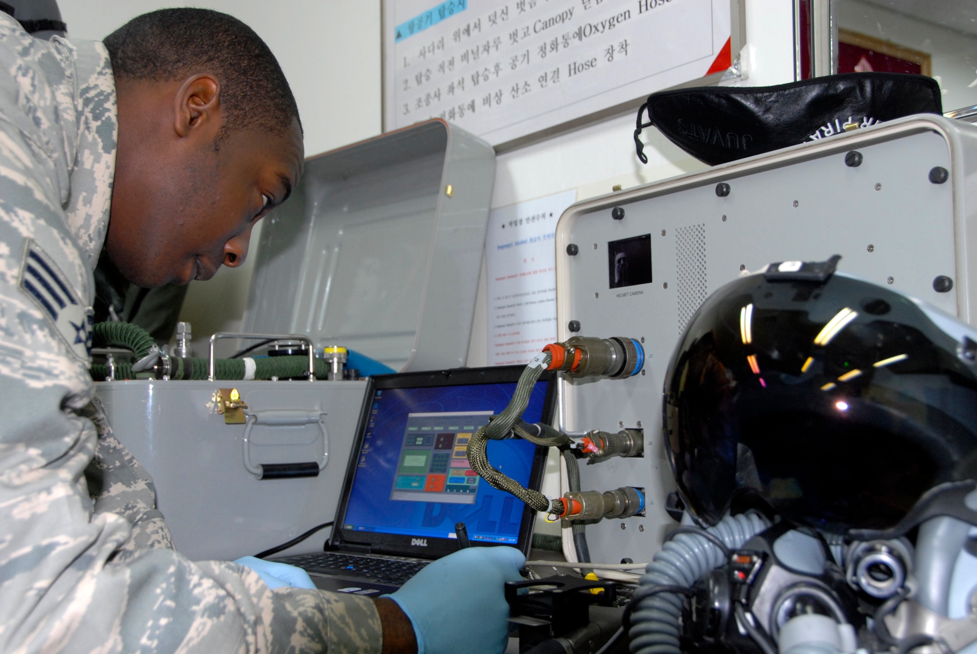 Senior Airman Willis Austin, 80tth Fighter Squadron Aircrew Flight Equipment technician, checks the Joint Helmet Mounted Cue System of a pilot participating in the Buddy Wing program, Nov. 19, 2008. The Buddy Wing program is designed to further increase U.S. Air Force and Republic of Korea Air Forces' interoperability in an aerospace conflict by having pilots from each air force fly with and against each other. (U.S. Air Force Photo by SSgt Jason Colbert)