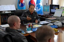 U.S. Air Force Capt. Matthew Eldredge and 1st Lt. Matt Crabb, 80th Fighter Squadron pilots, speak with Republic of Korea Air Forces' Brig. Gen. Jin, 19th Tactical Fighter Wing commander, while participating in the Buddy Wing program at Jungwon Air Base, Republic of Korea, Nov. 18, 2008. The Buddy Wing program is designed to further increase U.S. Air Force and ROKAF interoperability in an aerospace conflict by having pilots from each air force fly with and against each other. (U.S. Air Force Photo by SSgt Jason Colbert)