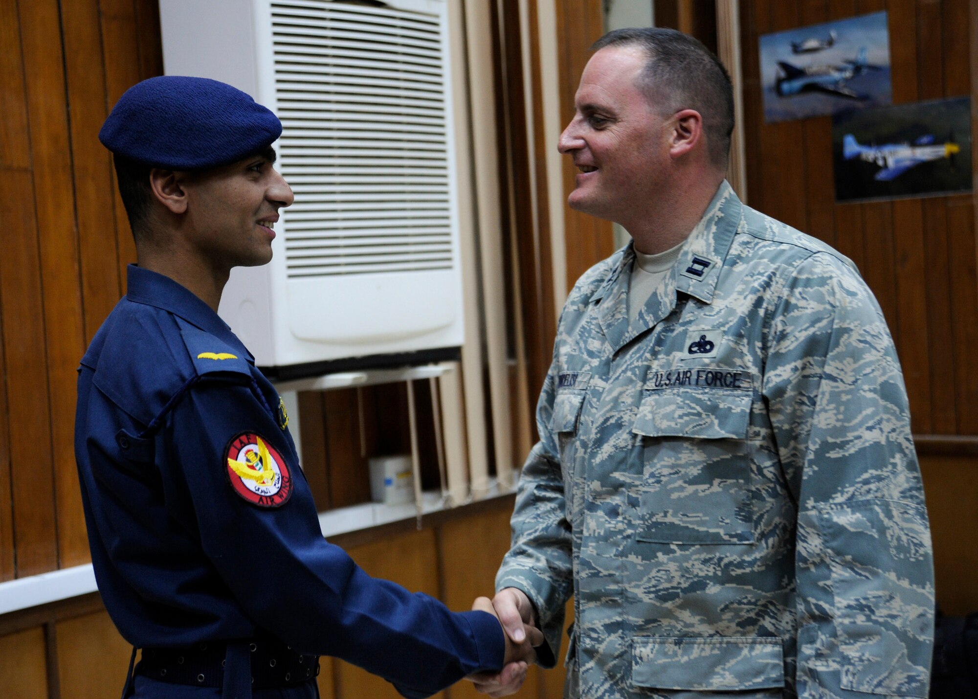 RUSTAMIYAH, Iraq -- Ali-Talib, Iraqi air force cadet, thanks U.S. Air Force Capt. Tom Fiordelisi for the training he has received at the Iraqi Military Academy al Rustamiyah, in Rustamiyah, Iraq on Nov. 10. Fiordelisi, an air advisor with the 321st Air Expeditionary Training Group, has taught courses in English Language Training, Air Power, Followership and Leadership for the Iraqi Air Force Training Wing. (U.S. Air Force photo/Staff Sgt. Paul Villanueva II)