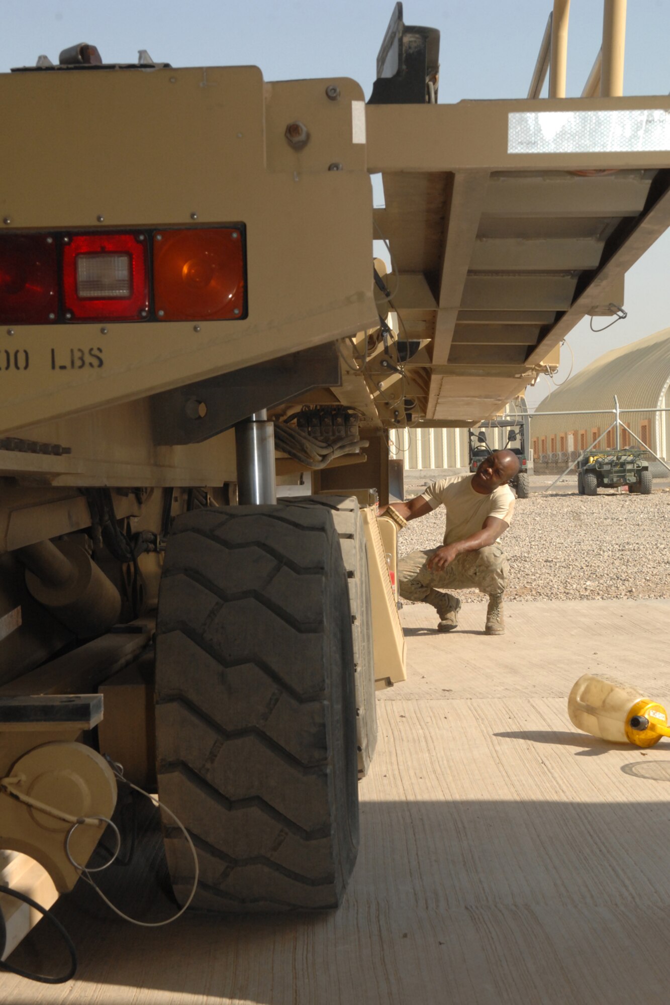 Staff Sgt. Dawaughn Washington performs a routine maintenance check on a 60K loader at Kirkuk Regional Air Base, Iraq, Nov 21 before returning  the vehicle to the 506th Expeditionary Logistics Readiness Squadron air transportation flight.  He is a fire truck maintainer with the 506 ELRS vehicle maintenance deployed from Yakota Air Base, Japan, and calls San Antonio, Texas, home. (U.S. Air Force photo/Senior Airman Randi Flaugh)