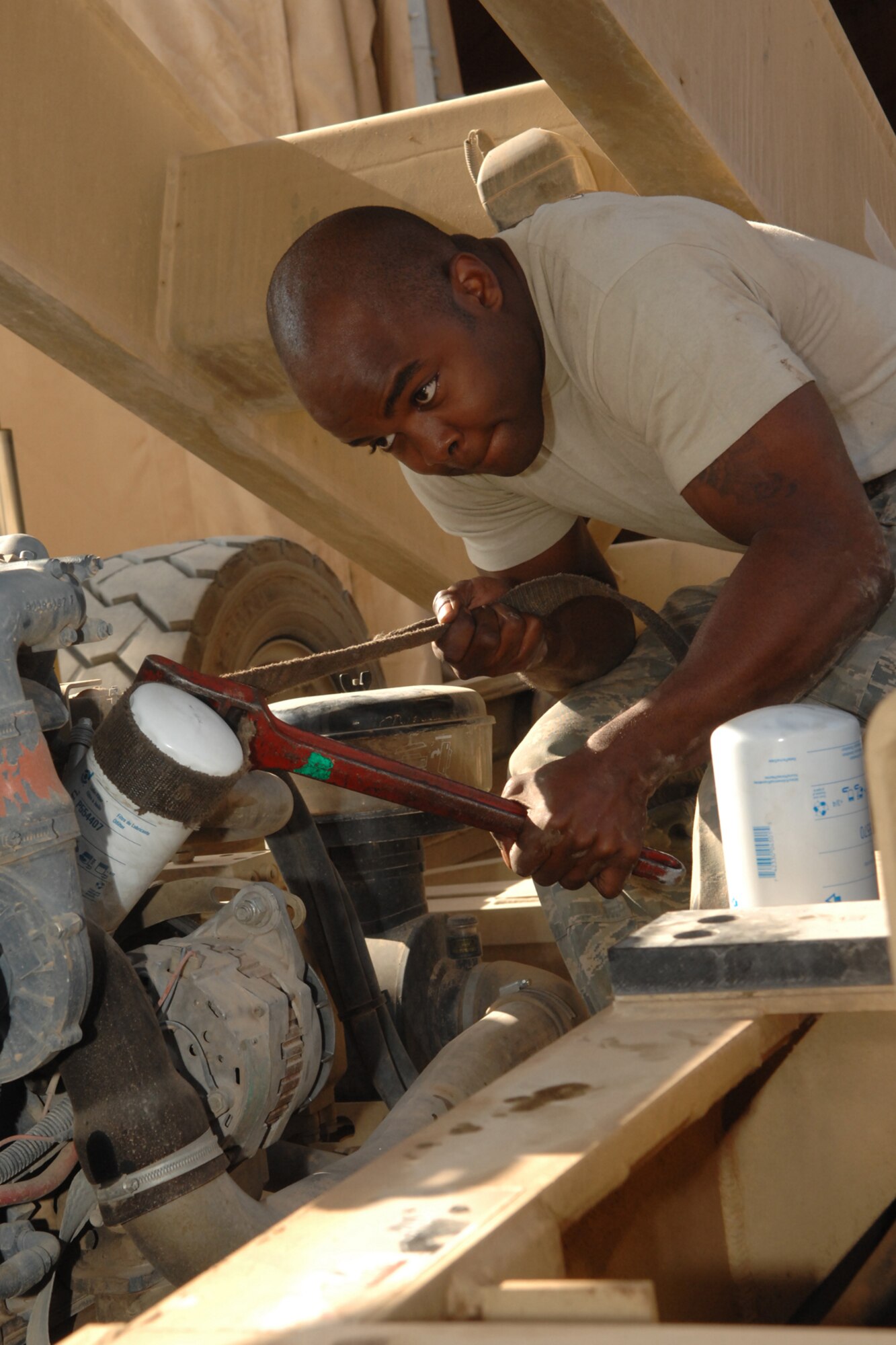 Staff Sgt. Dawaughn Washington removes a filter off a 60K loader at Kirkuk Regional Air Base, Iraq, Nov 21.  Sergeant Washington is performing routine maintenance on the vehicle before returning it to the 506th Expeditionary Logistics Readiness Squadron air transportation flight.  He is a fire truck maintainer with the 506 ELRS vehicle maintenance deployed from Yakota Air Base, Japan, and calls San Antonio, Texas, home. (U.S. Air Force photo/Senior Airman Randi Flaugh)
