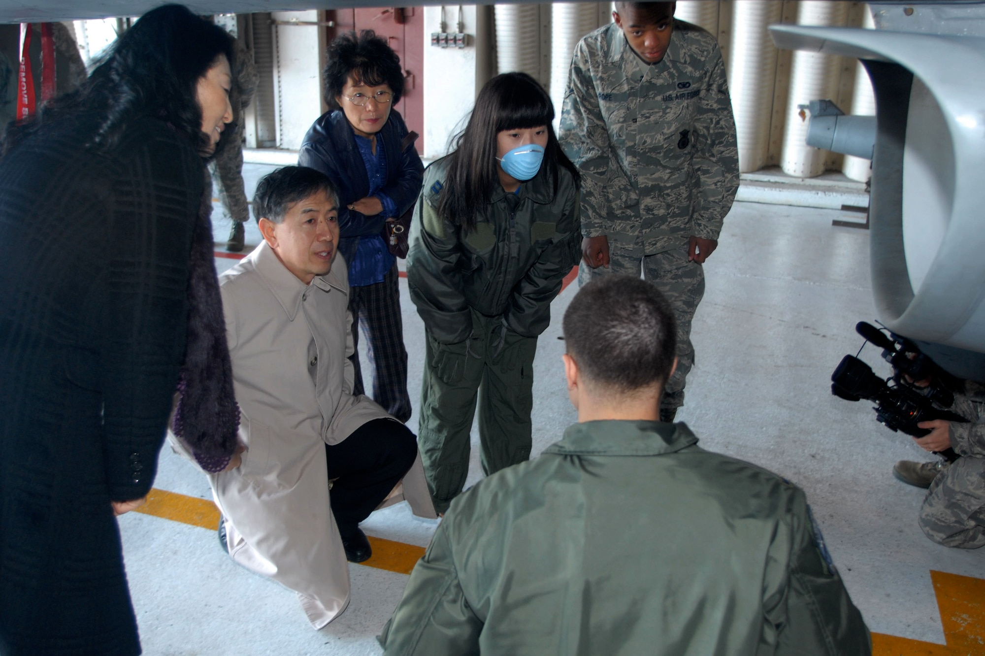 You Jin Pak and Airman Tamarias Pope are shown the exterior of an F-16 during Ms. Pak's visit to Kunsan Air Base, Republic of Korea, Nov. 21, 2008. Airman Tamarias Pope, 8th Security Forces Squadron, donated AB negative blood, which is rare among the Korean population, specifically for Ms. Pak and ultimately saved her life. (U.S. Air Force photo/Senior Airman Gustavo Gonzalez) 