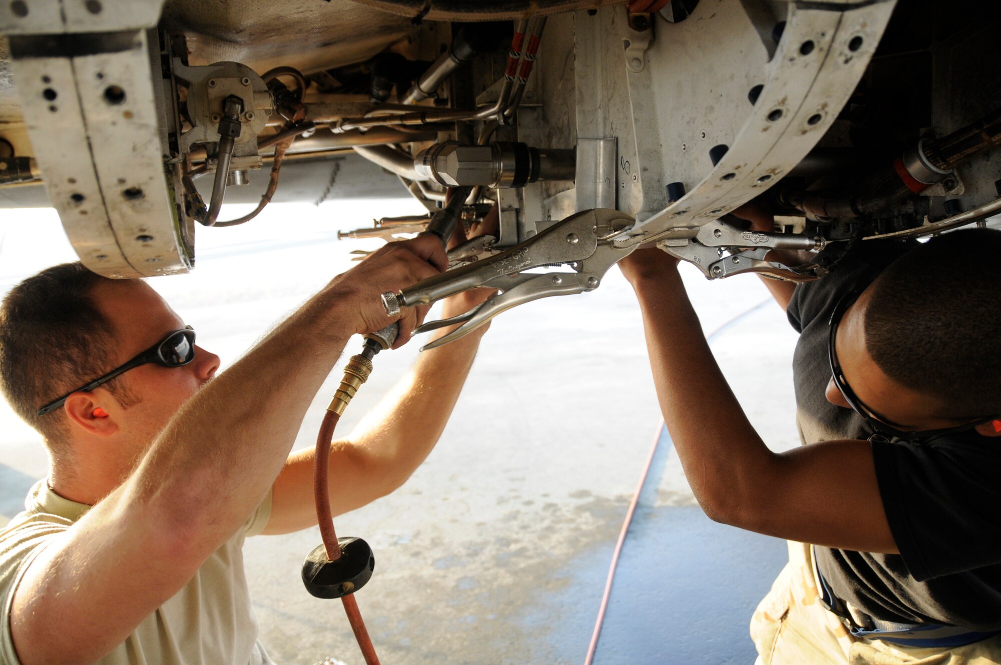 Tech. Sgt. Brian Hardwick and Airman 1st Class Jean-Michael Sibilly, both structural aircraft maintainer assigned to the 379th Expeditionary Maintenance Squadron, repair a B-1 engine nacelle that was damaged from a tire blow out at an undisclosed air base in Southwest Asia, Nov. 18, 2008. Sergeant Hardwick, a native of Santa Cruz, Calif., is deployed from Royal Air Force Mildenhall, U.K., and Airman Sibilly, a native of Charlotte Amalie, St. Thomas United States Virgin Island, is deployed from Ellsworth Air Force Base, S.D., both in support of Operations Iraqi and Enduring Freedom and Joint Task Force-Horn of Africa. (U.S. Air Force photo by Staff Sgt. Darnell T. Cannady/Released)