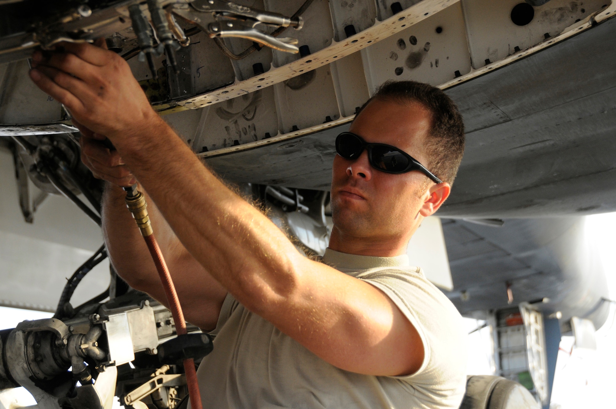 Tech. Sgt. Brian Hardwick, structural aircraft maintainer assigned to the 379th Expeditionary Maintenance Squadron, repairs the engine nacelle using an MC-2A air compressor Nov. 18, 2008, at an undisclosed air base in Southwest Asia. Sergeant Hardwick, a native of Santa Cruz, Calif., is deployed from Royal Air Force Mildenhall, U.K., in support of Operations Iraqi and Enduring Freedom and Joint Task Force-Horn of Africa. (U.S. Air Force photo by Staff Sgt. Darnell T. Cannady/Released)
