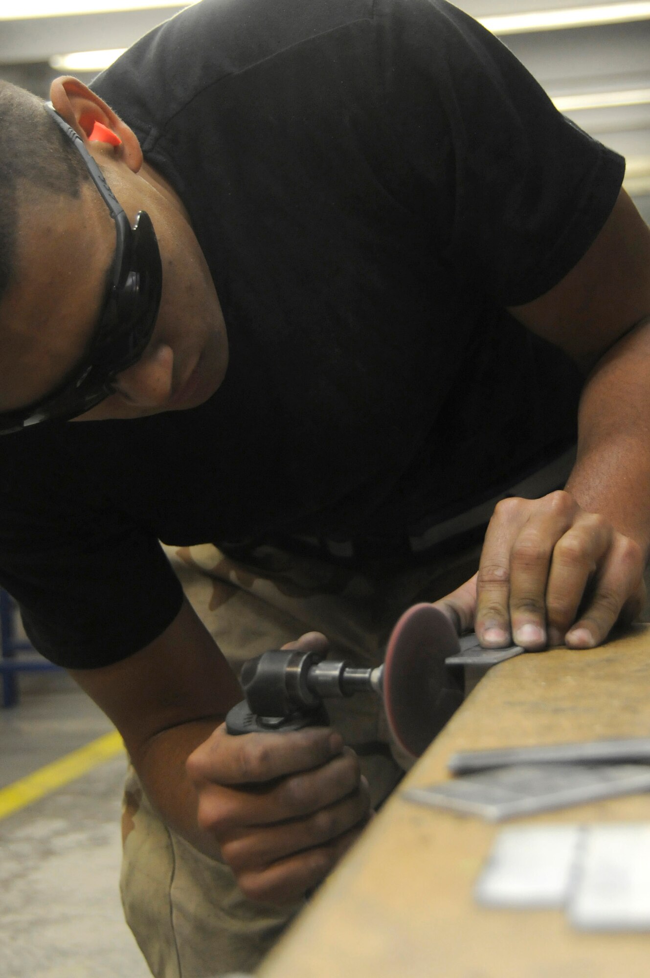 Airman 1st Class Jean-Michael Sibilly, structural aircraft maintainer assigned to the 379th Expeditionary Maintenance Squadron, uses a cutting wheel tube to make brackets fabrications for a B-1 aircraft Nov. 15, 2008, at an undisclosed air base in Southwest Asia. Airman Sibilly, a native of Charlotte Amalie, St. Thomas United States Virgin Island, is deployed from Ellsworth Air Force Base, S.D., in support of Operations Iraqi and Enduring Freedom and Joint Task Force-Horn of Africa. (U.S. Air Force photo by Staff Sgt. Darnell T. Cannady/Released)