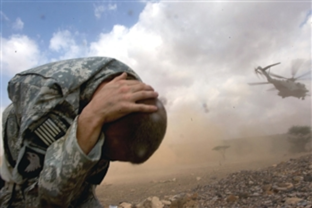 U.S. Army Sgt. William Steele braces against the rotor wash of a CH-53 Sea Stallion helicopter with Marine Heavy Helicopter Squadron 464 as it takes off after delivering medical supplies and personnel during a medical civil affairs project, MEDCAP, in Beya-Addey, Djibouti, Nov. 16, 2008. 
