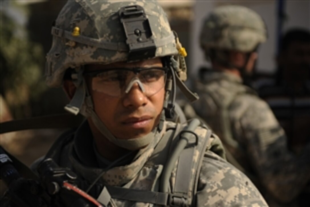 U.S. Army Staff Sgt. Henry Flores III provides security during a patrol to assess the markets and needs of the people of Diwaniyah, Iraq, Nov. 13, 2008. Flores and fellow soldiers are assigned to the 2nd Battalion, 8th Infantry Regiment, 2nd Brigade Combat Team, 4th Infantry Division.