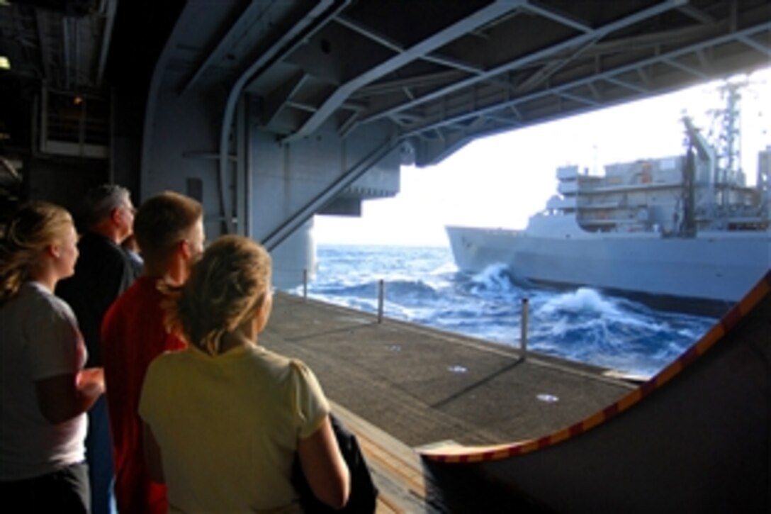 Friends and family of the Nimitz-class aircraft carrier USS Ronald Reagan's sailors watch intently as Ronald Reagan participates in a fueling at sea with the fast combat support ship USNS Bridge, Nov. 20, 2008. The Reagan is on a routine deployment currently operating in the 3rd Fleet area of operation.