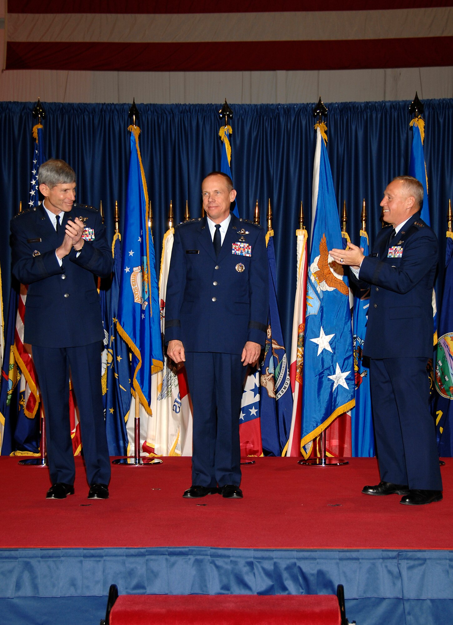 Gen. Donald J. Hoffman is congratulated after assuming command of the Air Force Materiel Command Nov. 21 at Wright-Patterson Air Force Base, Ohio.  Air Force chief of staff Gen. Norton Schwartz (left) presided over the ceremony during which Hoffman succeeded Gen. Bruce Carlson (right), who served as AFMC commander since August 2005.  The change of command was held inside the National Museum of the U.S. Air Force. (U.S. Air Force photo/Ben Strasser)