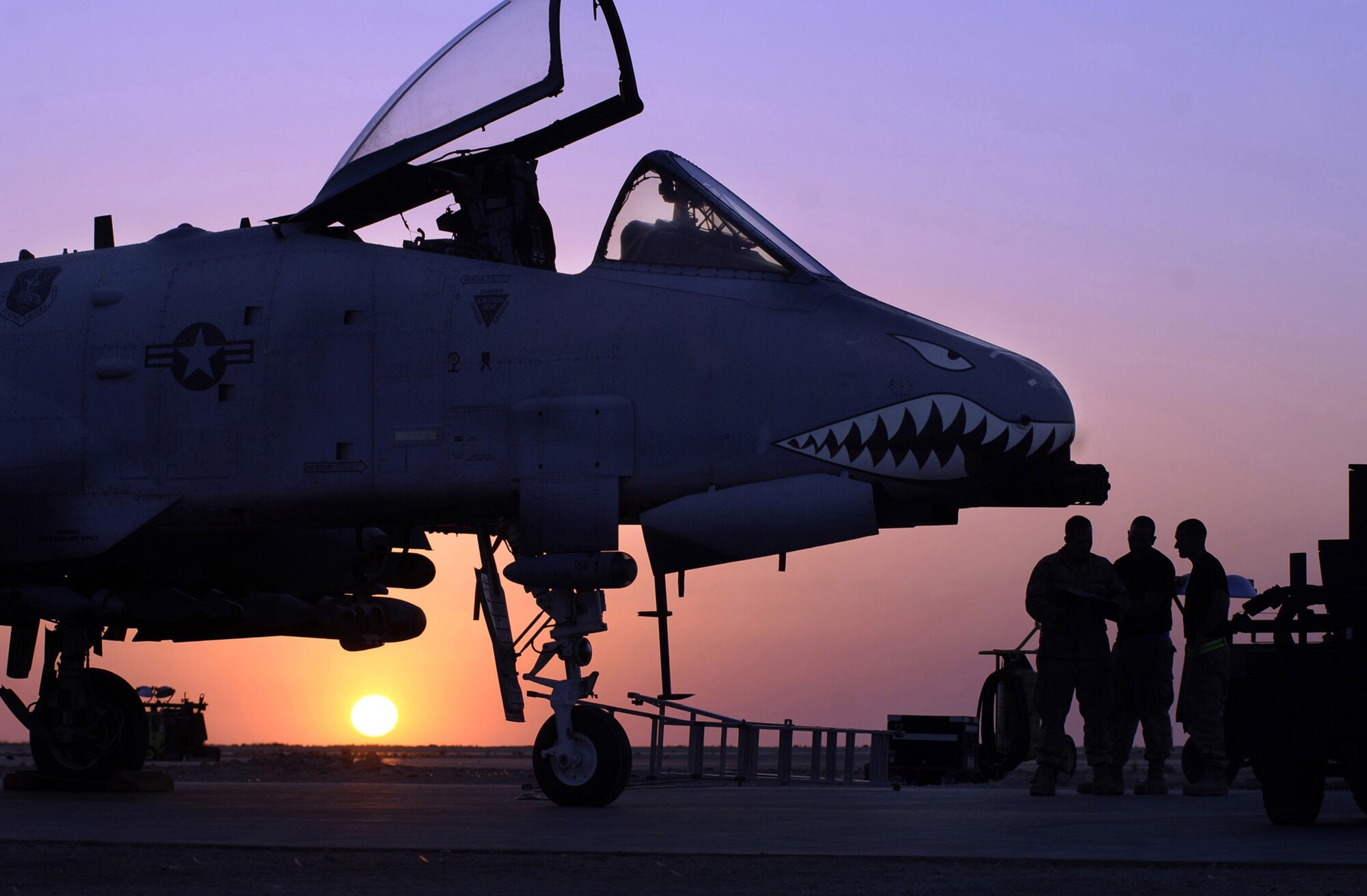 Senior Airman Joseph Cordero, Staff Sgt. Andrew House and Staff Sgt. Barrett Read trouble shoot an electronic error on an A-10 Thunderbolt II on the flightline at Al Asad Air Base, Iraq. An A-10 like this one, provided close-air support and performed shows of force Nov. 21 to deter enemy activity in Afghanistan. (U.S. Air Force photo/Tech. Sgt. Cecilio M. Ricardo Jr.)
