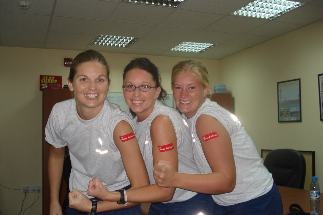 Members from the North Dakota Air National Guard flex their muscles and show off their Happy Hooligan tattoos before competing in the Fire Muster competition in October, 2008.