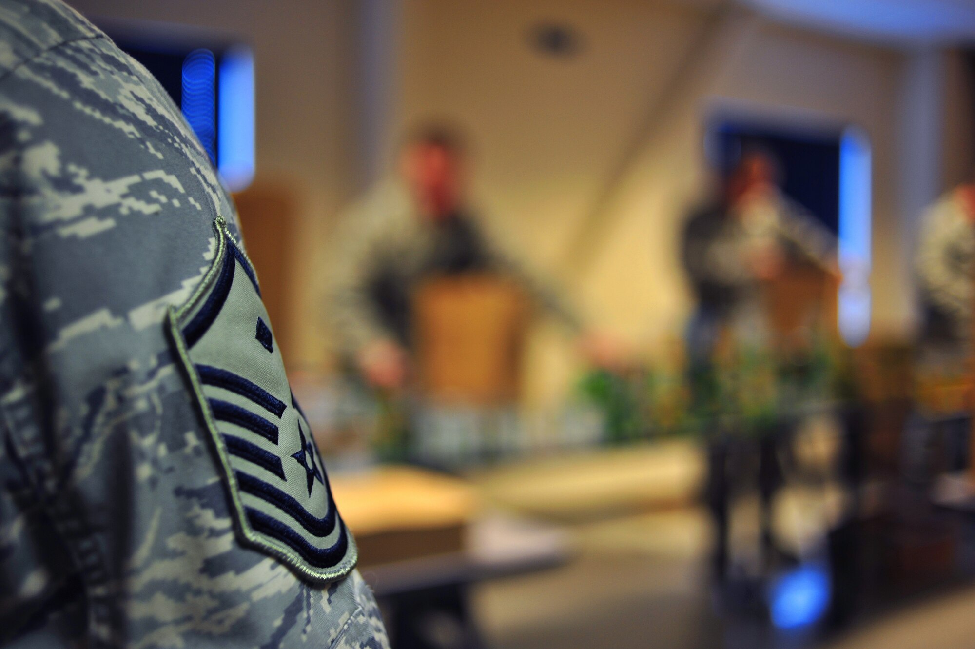 A first sergeant looks on as an Airman Leadership School class fills bags with food Nov. 21 at the 354th Civil Engineering "Prime Beef" Building. ALS took part in Operation: Warm Heart which is a volunteer activity that provides food for families in need during the holiday season. (U.S. Air Force photo by Airman 1st Class Willard E. Grande II)