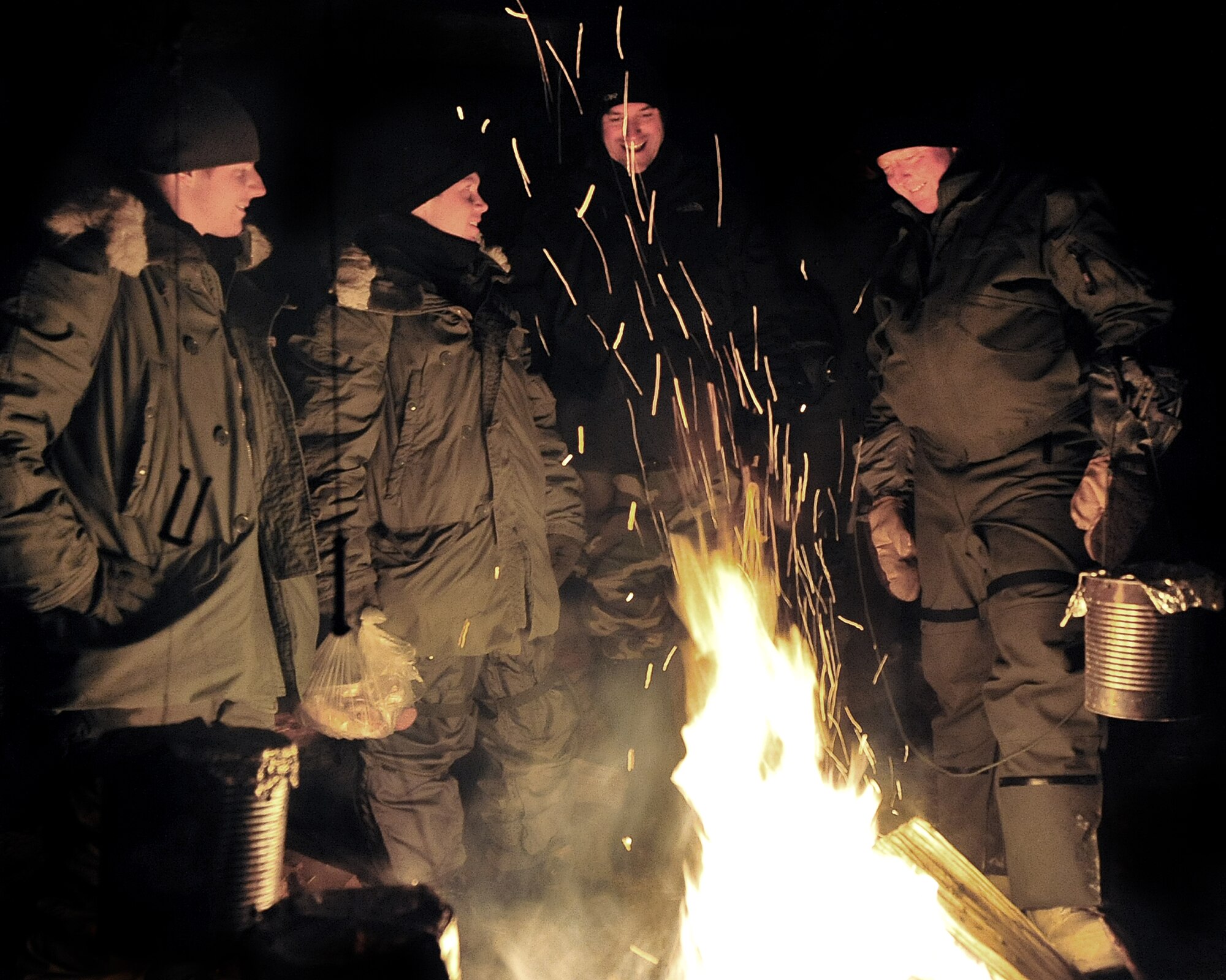 Lt. Gen. Dana T. Atkins, commander of Alaskan Command, Alaskan North American Aerospace Defense Command Region, Joint Task Force Alaska and 11th Air Force, visits with fellow Airmen Nov. 20, during their stay at Arctic Survival School. Cool School, as it is more commonly known, is a rigorous five-day course in which survival techniques suited for an arctic environment are taught and later put to the test. (U.S. Air Force photo by Airman 1st Class Willard E. Grande II)