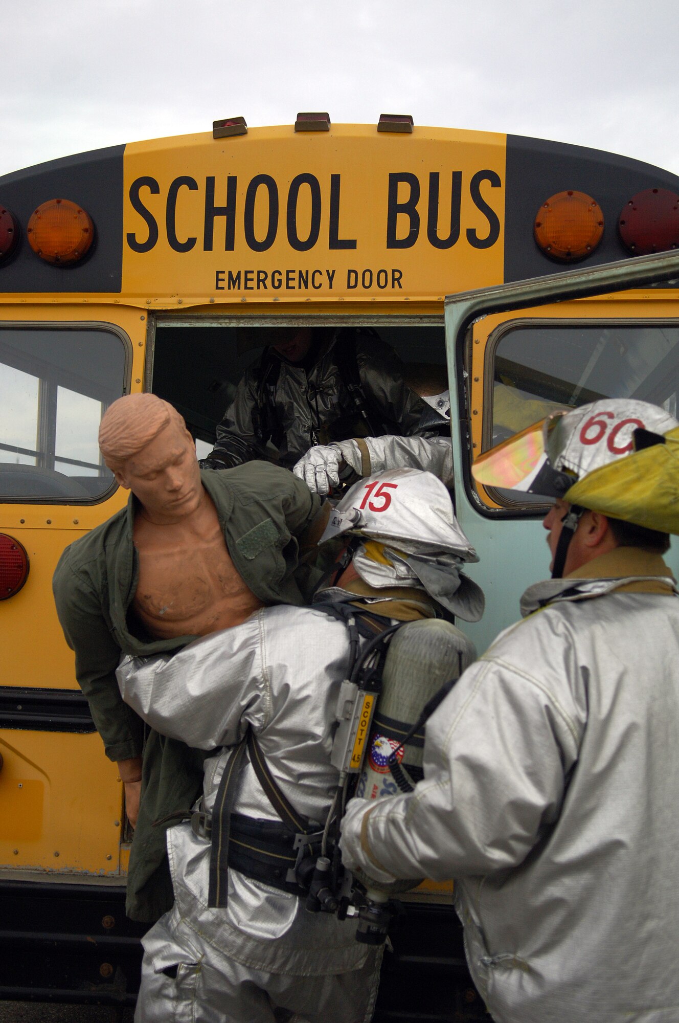 MINOT AIR FORCE BASE, N.D. –Scott Sharp and David Stiel, both 5th Civil Engineer Squadron firefighters, rescue a “casualty” from a simulated accident between a school bus and a fire engine during a major accident response exercise (MARE) here Nov. 18. The MARE is used to test the response capabilities of the base’s emergency response teams during inclement weather conditions. (US Air Force Photo by Senior Airman Cassandra Jones)