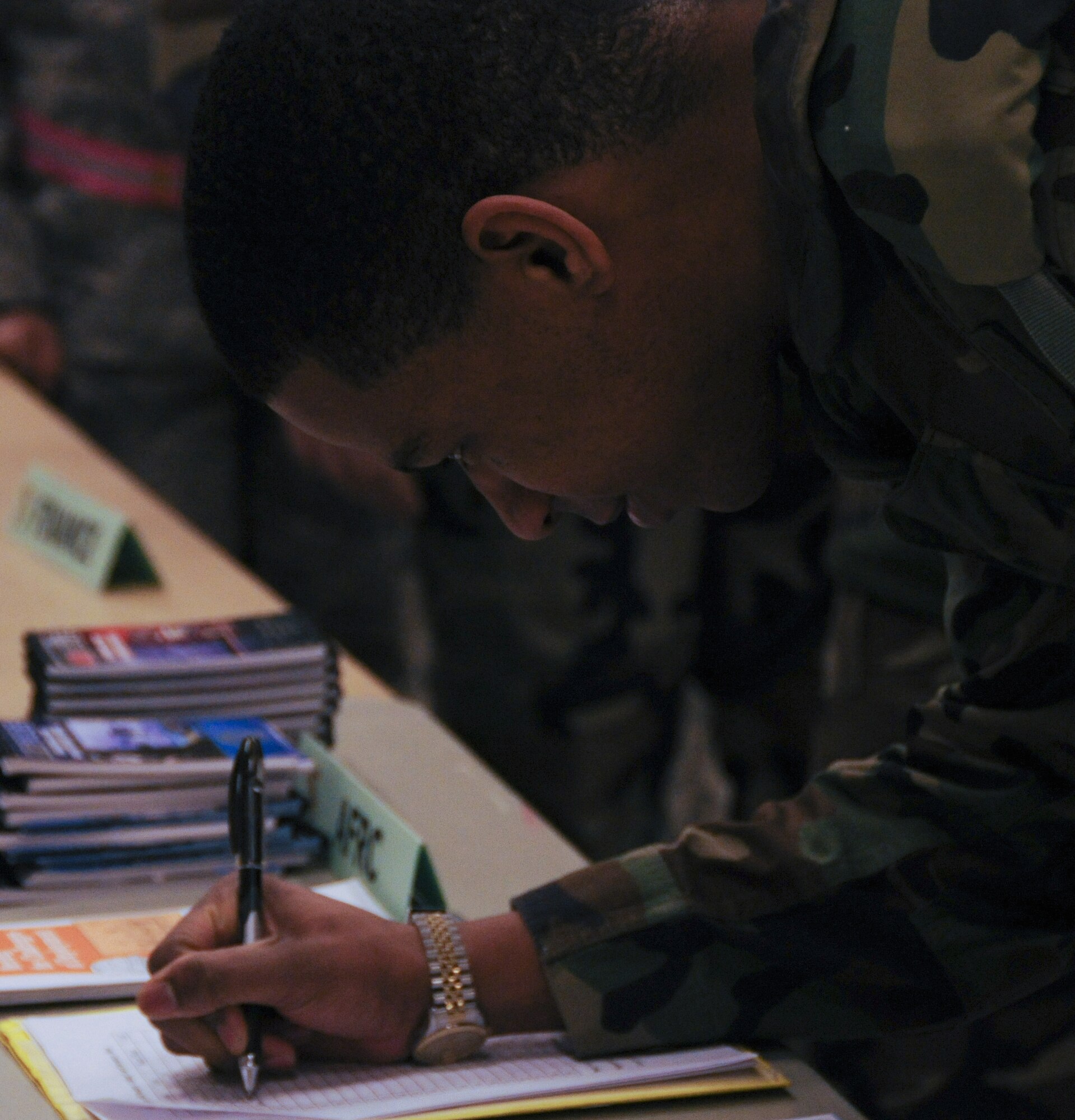 Airman 1st Class Diontae Edwards signs paper-work Nov. 21, 2008 at Eielson Air Force Base, Alaska. Airman Edwards is participating in a deployment readiness exercise. This exercise helps prepares Airmen to deploy at a moment's notice. (U.S. Air Force photo/Airman Laura Max)