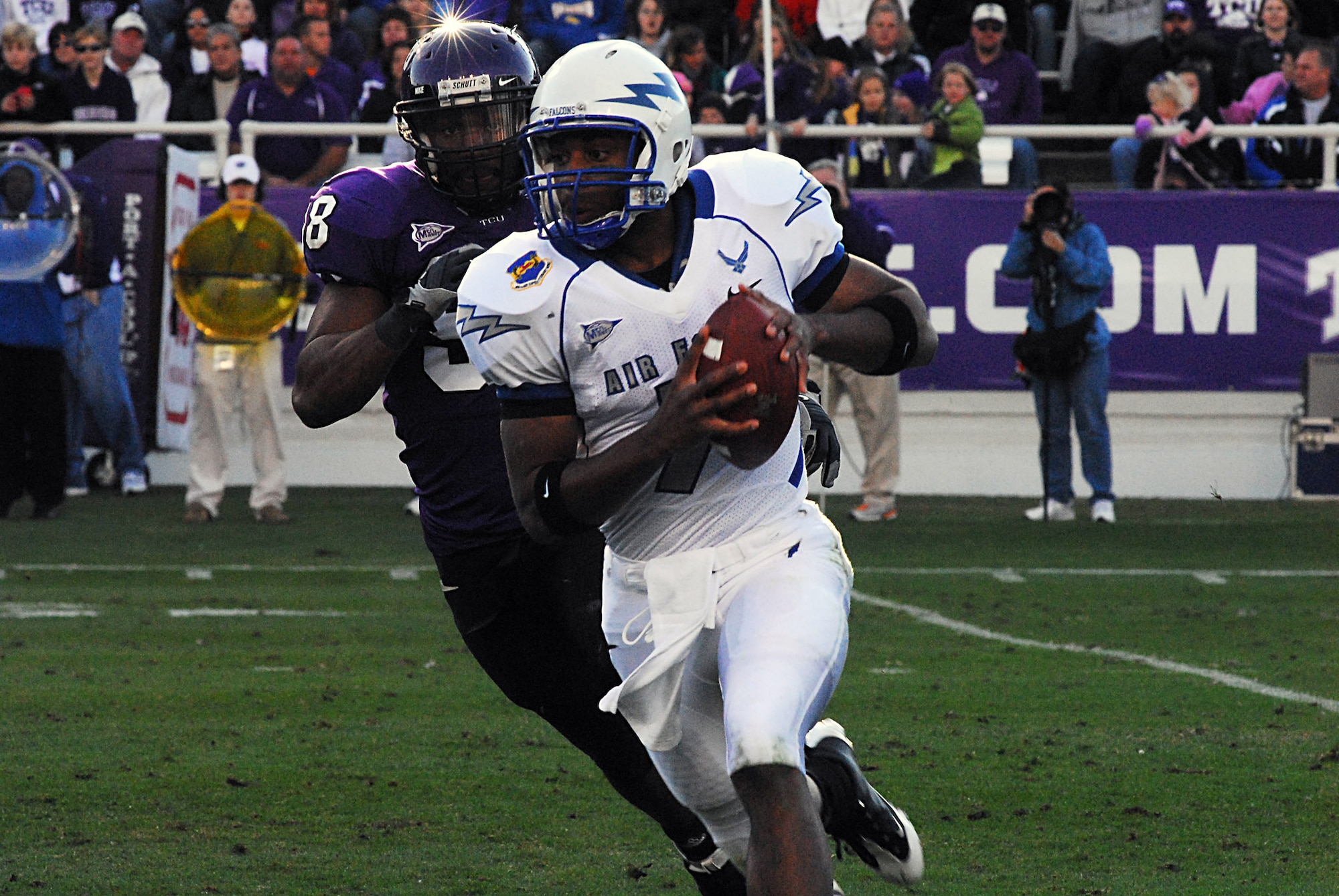 Air Force Falcon quarterback Tim Jefferson is chased out of the pocket by Texas Christian University defensive end Jerry Hughes Nov. 22 in Amon G. Carter Stadium in Fort Worth, Texas. The Frogs beat the Falcons, 44-10. (U.S. Air Force photo/Tech. Sgt. Julie Briden-Garcia)