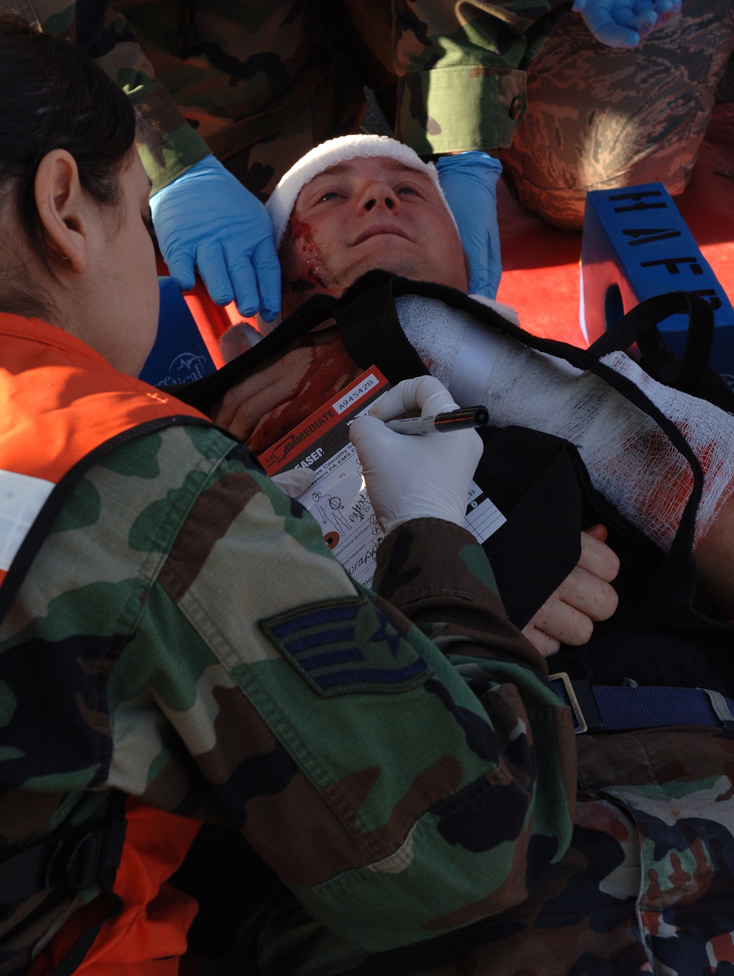 An Airman from the 49th Medical Group fills out a Mass Caualty Incident Tag after a simulated explosion on Holloman Air Force Base, N.M., Nov. 20. The Airmen were participating in a week-long exercise, Coronet Gold Rush 08-08, to test their skills in the most realistic manner possible. (U.S. Air Force photo/Airman 1st Class Michael Means)