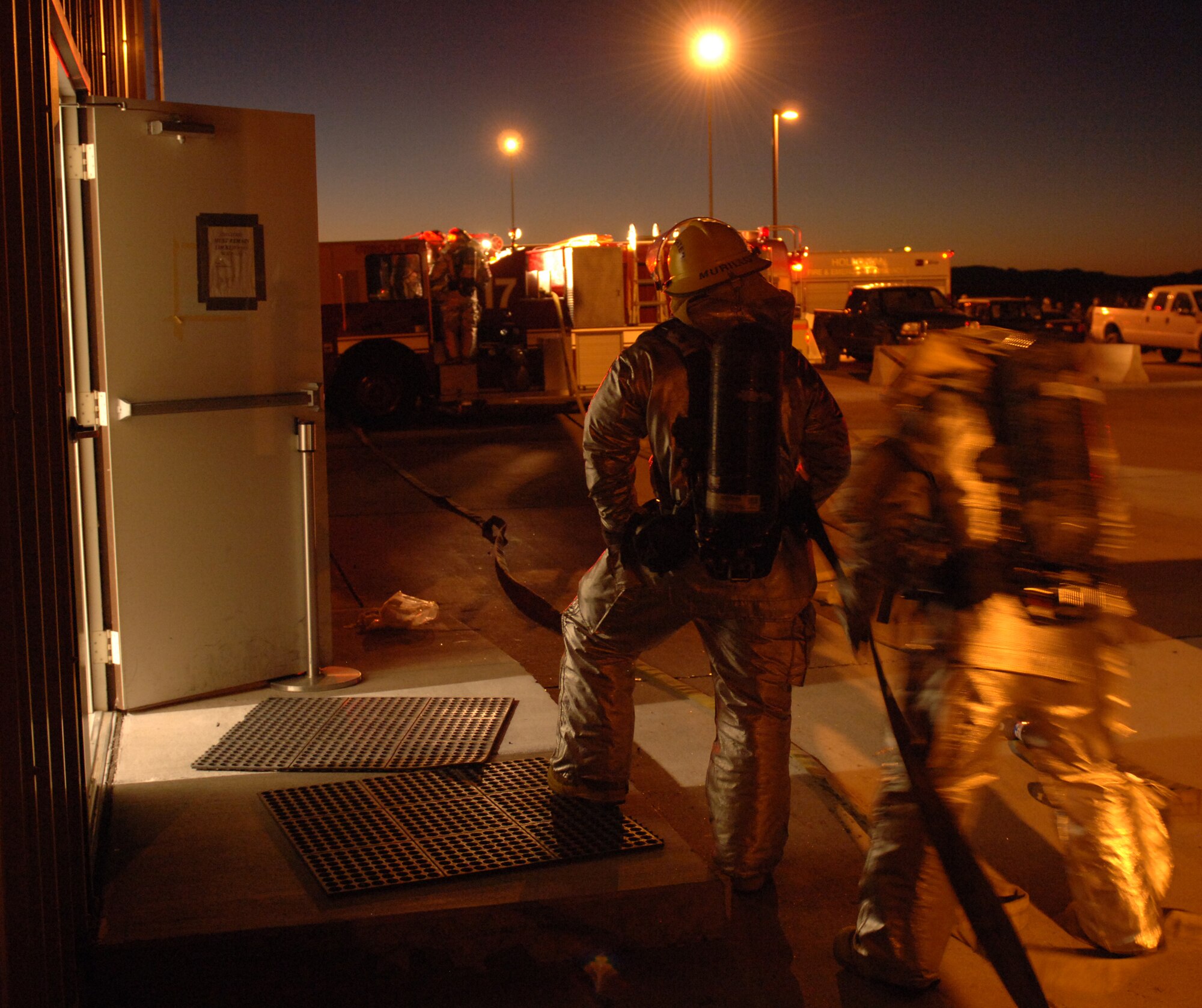 Airmen from the 49th Civil Engineer Squadron Fire Department respond to a simulated building fire at Holloman Air Force Base, N.M., Nov. 20. The Airmen were participating in a week-long exercise, Coronet Gold Rush 08-08, to test their skills in the most realistic manner possible. (U.S. Air Force photo/Airman 1st Class Michael Means)