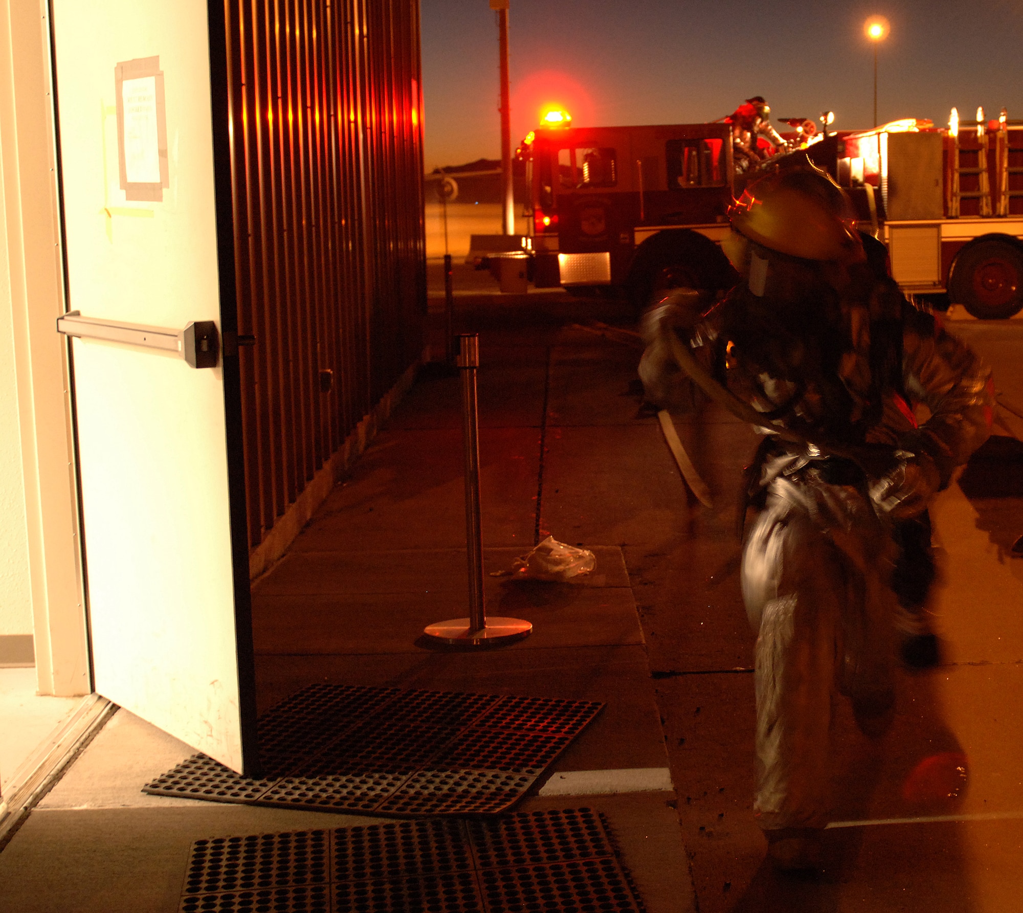 Airmen from the 49th Civil Engineer Squadron Fire Department respond to a simulated building fire at Holloman Air Force Base, N.M., Nov. 20. The Airmen were participating in a week-long exercise, Coronet Gold Rush 08-08, to test their skills in the most realistic manner possible. (U.S. Air Force photo/Airman 1st Class Michael Means)