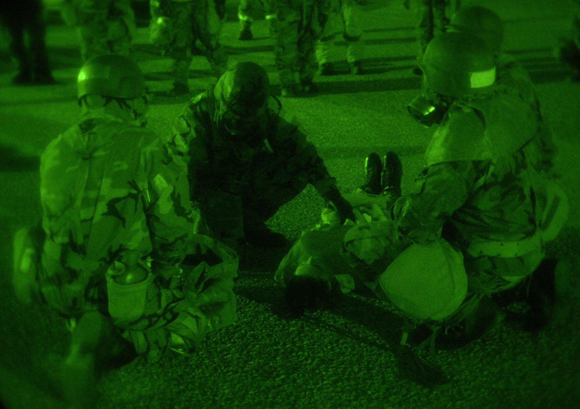 Airmen from the 49th Logistics Readiness Squadron perform self-aid and buddy care on a victim with simulated injuries at Holloman Air Force Base, N.M., Nov. 20. The Airmen were participating in a week-long exercise, Coronet Gold Rush 08-08, to test their skills in the most realistic manner possible. (U.S. Air Force photo/Airman 1st Class Michael Means)