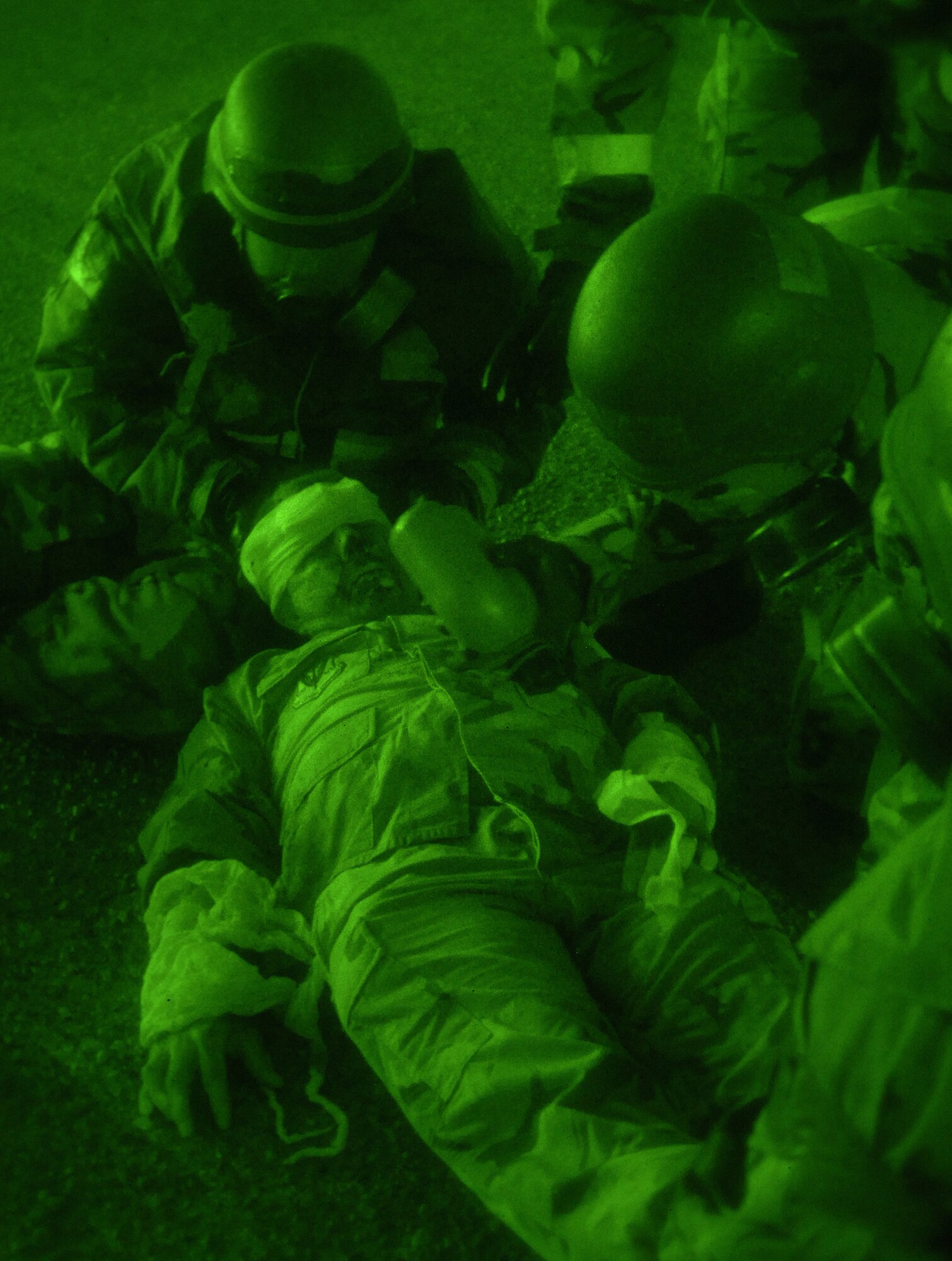 Airmen from the 49th Logistics Readiness Squadron perform self-aid and buddy care on a victim with simulated injuries at Holloman Air Force Base, N.M., Nov. 20. The Airmen were participating in a week-long exercise, Coronet Gold Rush 08-08, to test their skills in the most realistic manner possible. (U.S. Air Force photo/Airman 1st Class Michael Means)