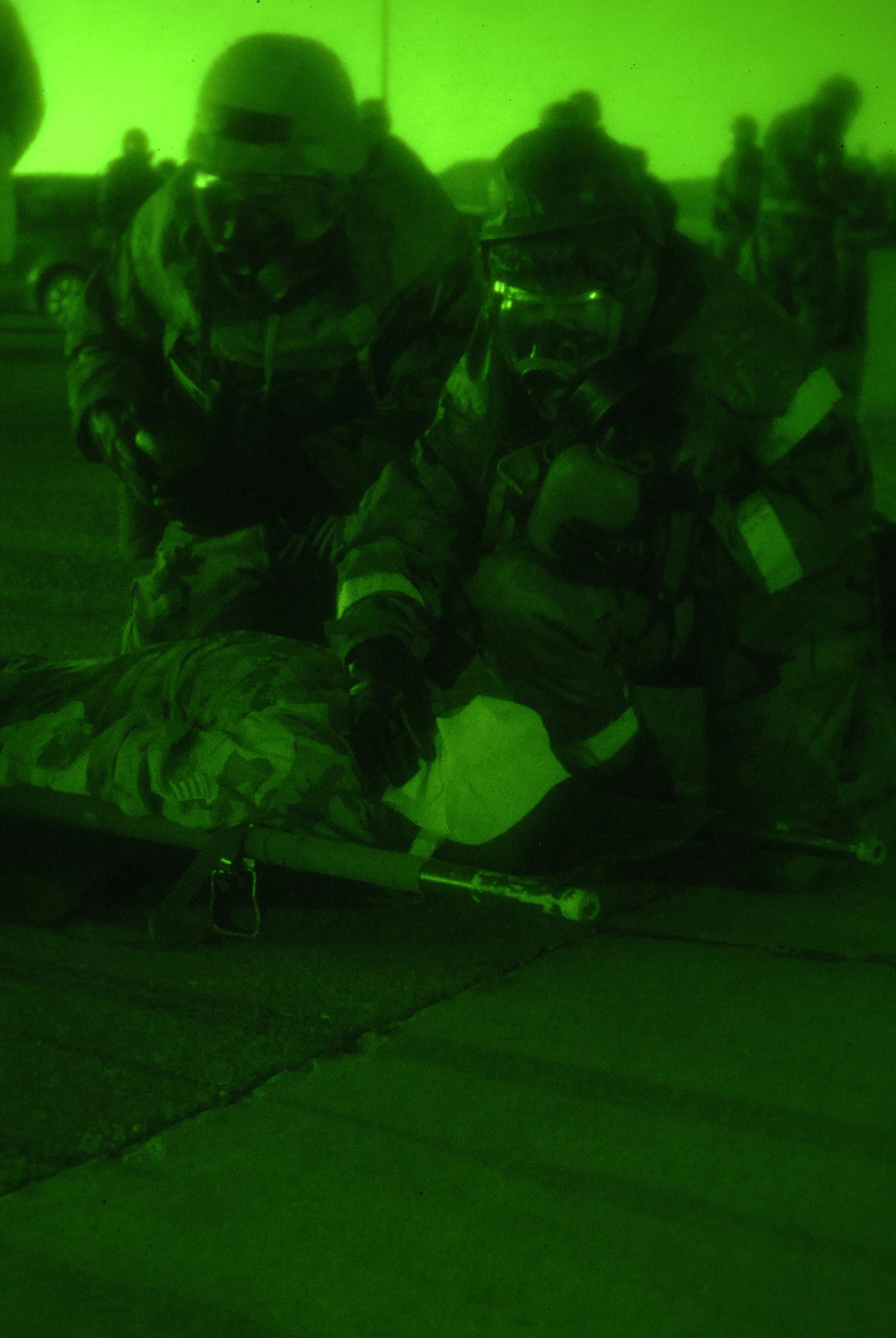 Airmen from the 49th Logistics Readiness Squadron perform self-aid and buddy care on a victim with simulated injuries at Holloman Air Force Base, N.M., Nov. 20. The Airmen were participating in a week-long exercise, Coronet Gold Rush 08-08, to test their skills in the most realistic manner possible. (U.S. Air Force photo/Airman 1st Class Michael Means)