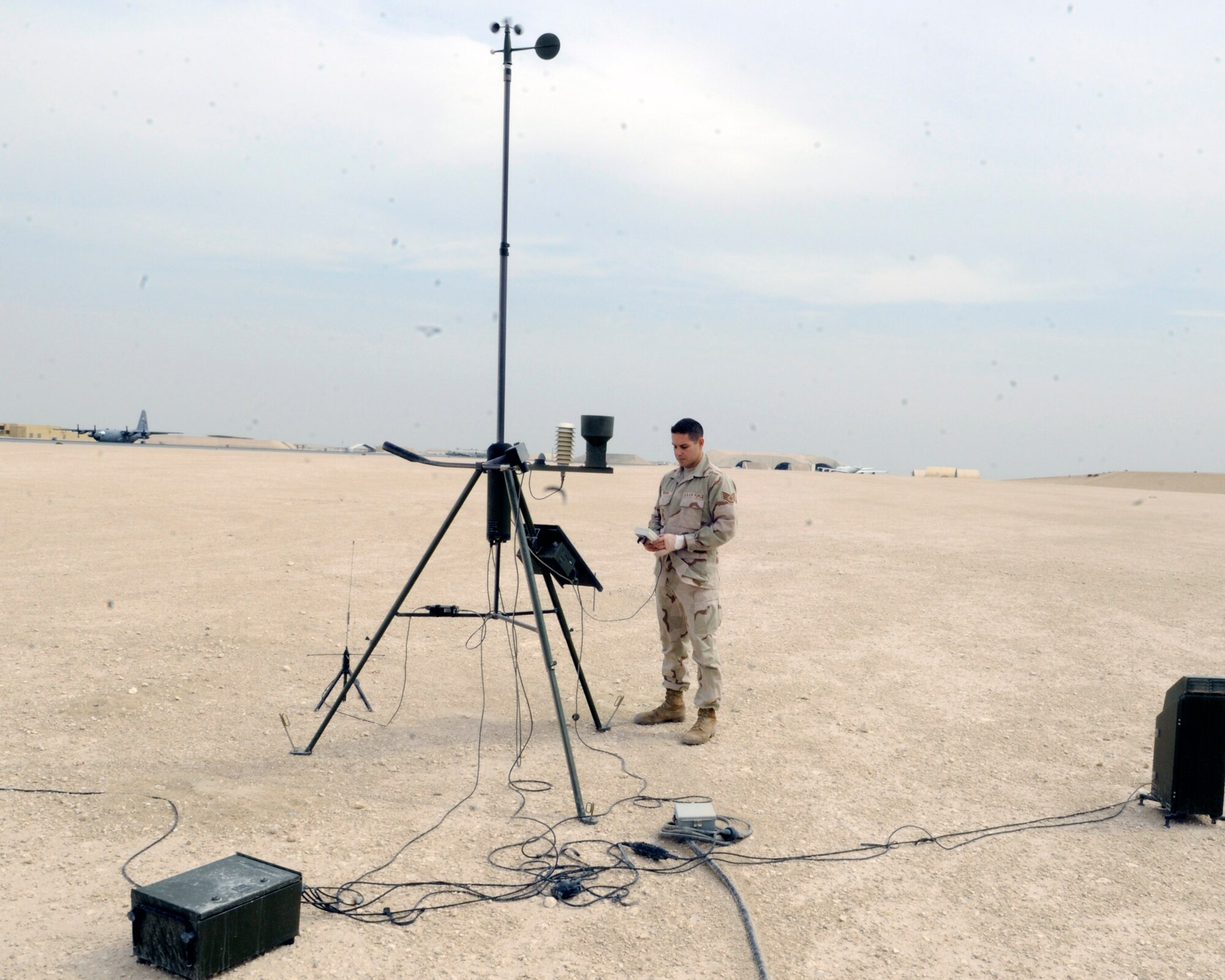 Staff Sgt. Kevin Fedon, a weather forecaster assigned to the 379th Expeditionary Operations Support Squadron at an air base in Southwest Asia, checks weather readouts, including temperature, wind speed, wind direction and precipitation, at a remote weather sensor. The weather readings are put into a weather model to help predict weather patterns and are used for daily reports to aircrews preparing for missions. Sergeant Fedon is a native of Lincoln, Neb., and is an Air National Guardsman deployed from Offutt Air Force Base, Neb. (U.S. Air Force photo/Tech. Sgt. Michael Boquette)