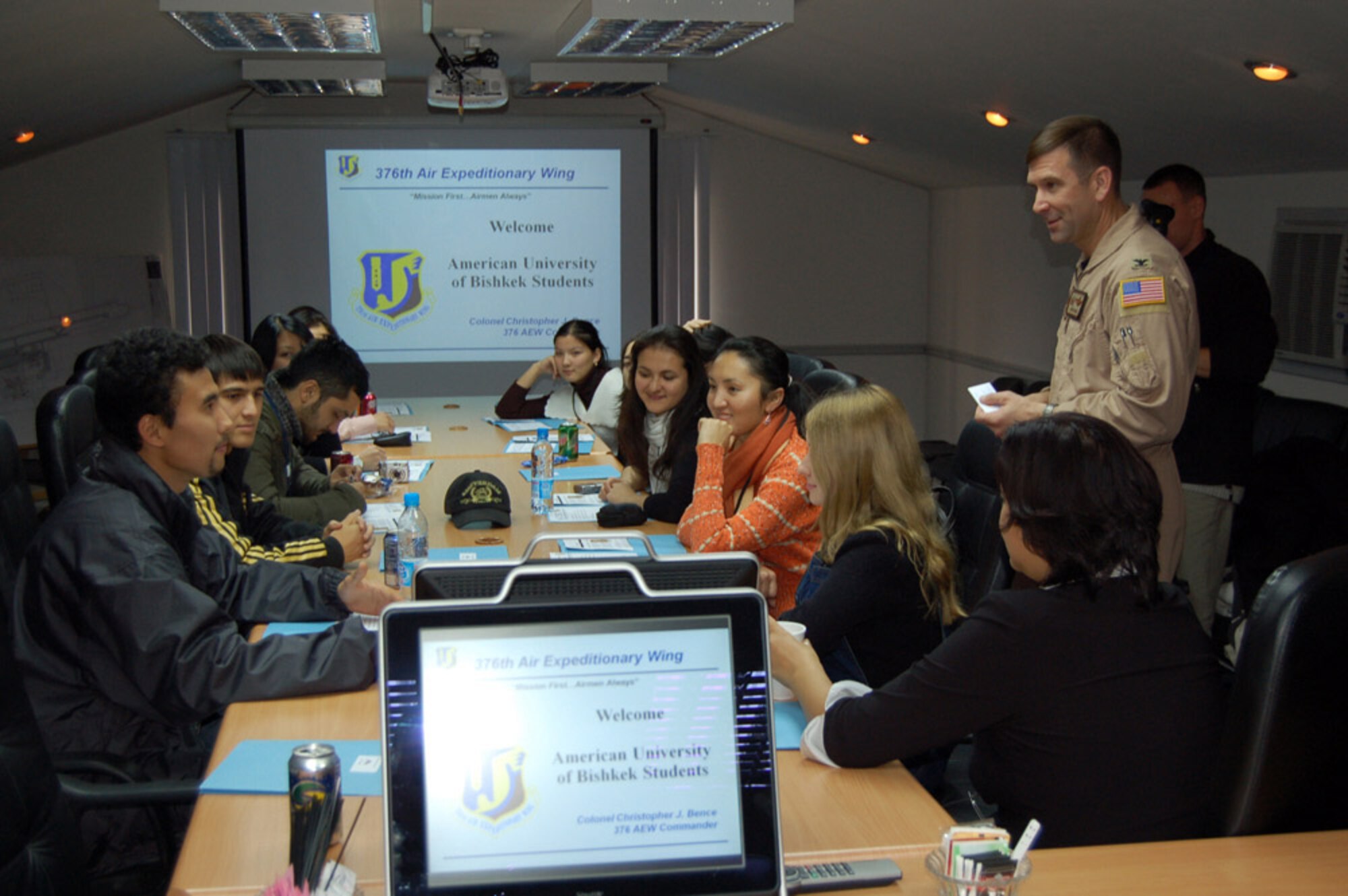 Col. Christopher Bence gives a mission briefing to students from the American University of Central Asia during a Nov. 5 visit to Manas Air Base, Kyrgyzstan. Students learned about the mission and the Airmen who serve at the base. Colonel Bence is the 376th Air Expeditionary Wing commander. (U.S. Air Force photo/Senior Master Sgt. Patrick J. McCracken) 

