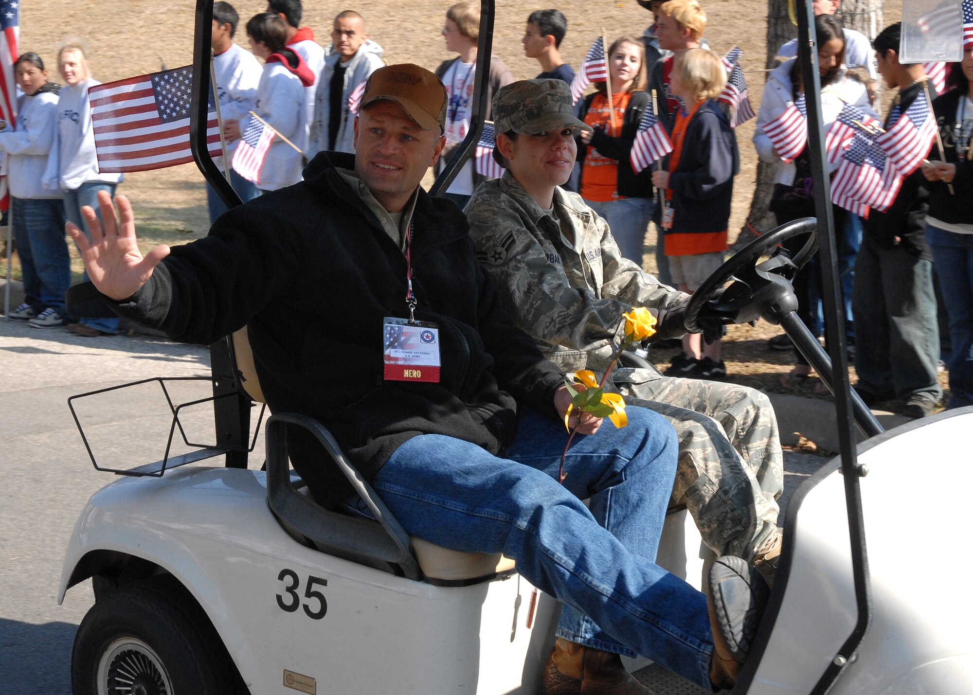 A wounded warrior rides with a military escort from Goodfellow Air Force Base and waves to the crowd at the Hunt for Heroes parade through downtown San Angelo on Nov. 21.  The parade gave members of the Goodfellow and San Angelo communities the opportunity to come out and show support for the wounded warriors who were participating in the hunt.  (U.S. Air Force photo by Senior Airman Kasabyan Musal).