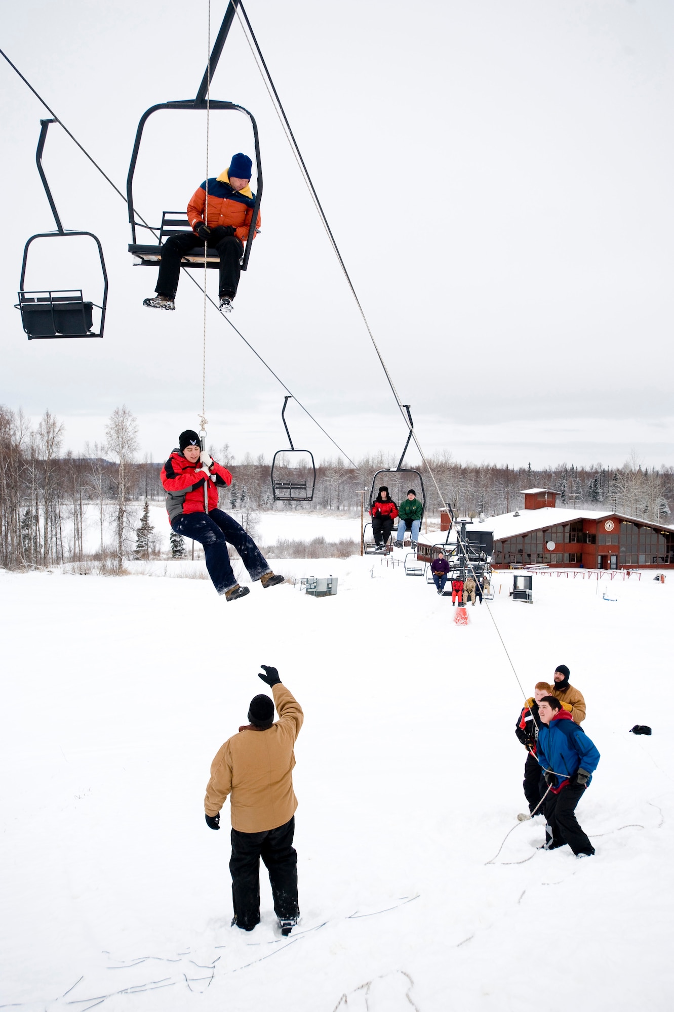 ELMENDORF AIR FORCE BASE, Alaska -- Laura Peterson, a volunteer for ski patrol, is lowered from the ski lift at Hillberg Ski Hill Nov. 23. The ski patrols performed training on ski-lift evacuation prior to Hillberg's opening this week. (U.S. Air Force photo/Senior Airman Jonathan Steffen)