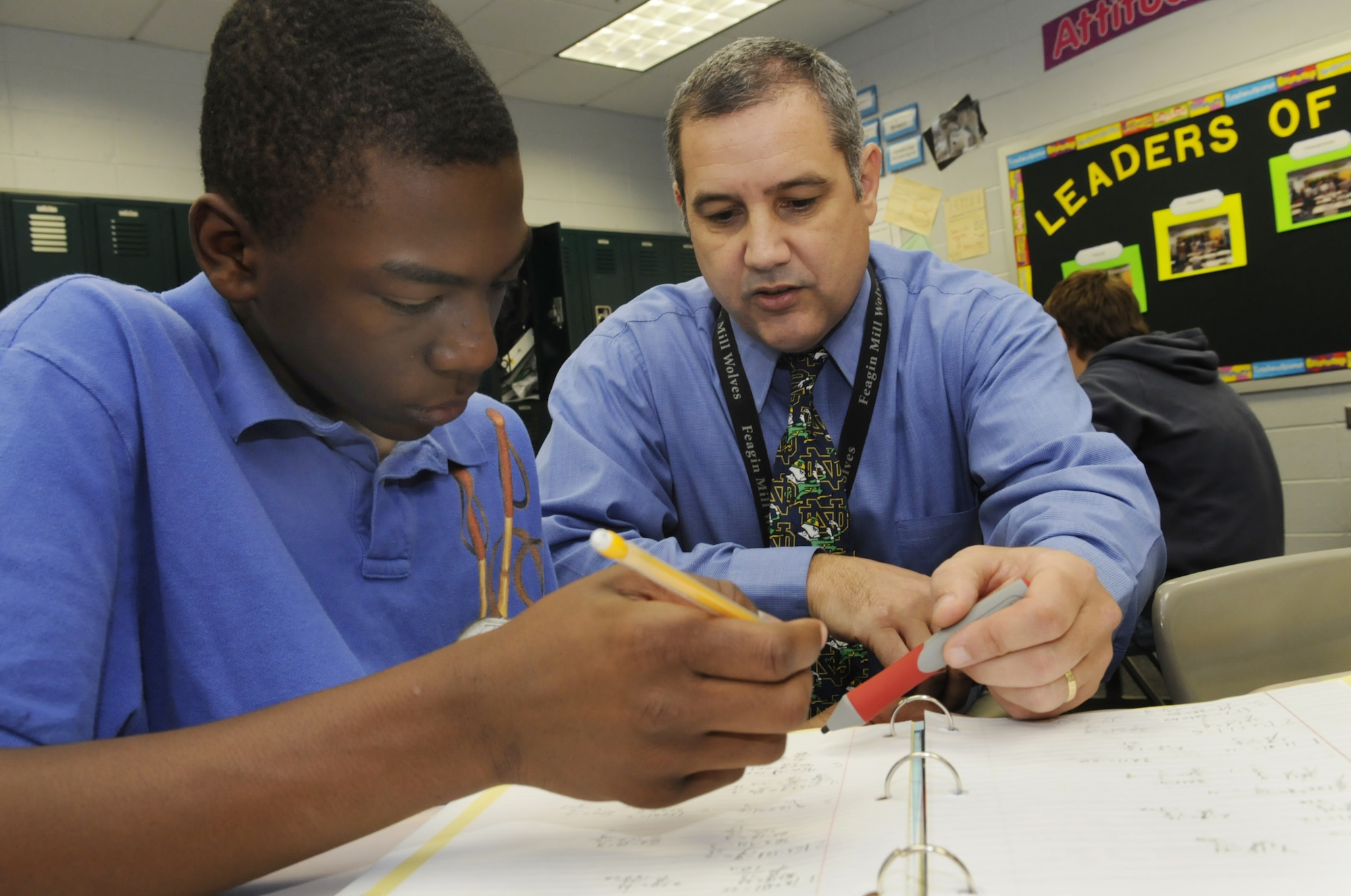 Eight grade student Caribe Polk gets some assistance from Chris Shumway, math teacher, at Feagin Mill Middle School Nov. 7. U. S. Air Force photo by Sue Sapp