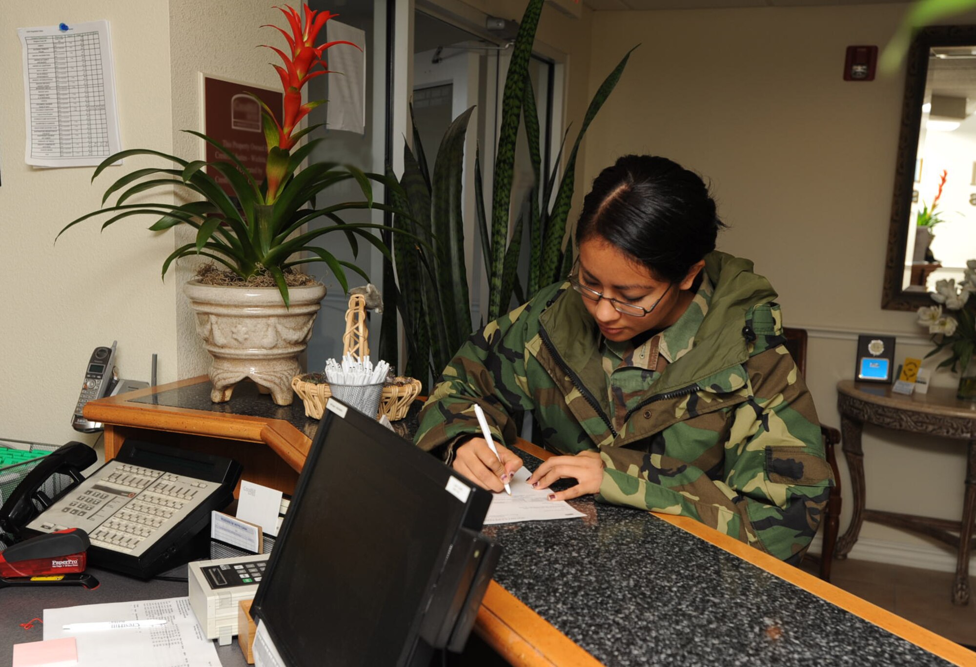 Senior Airman Brenda Ramon checks out from her lodging provider during the 931st Air Refueling Group's Unit Training Assembly in November. Group members who need lodging while on military orders will soon use a new automated phone service to make reservations. Airman Ramon is assigned to the headquarter staff of the 931st ARG, an Air Force Reserve unit at McConnell Air Force Base, Kan. (U.S. Air Force photo/Tech. Sgt. Jason Schaap)