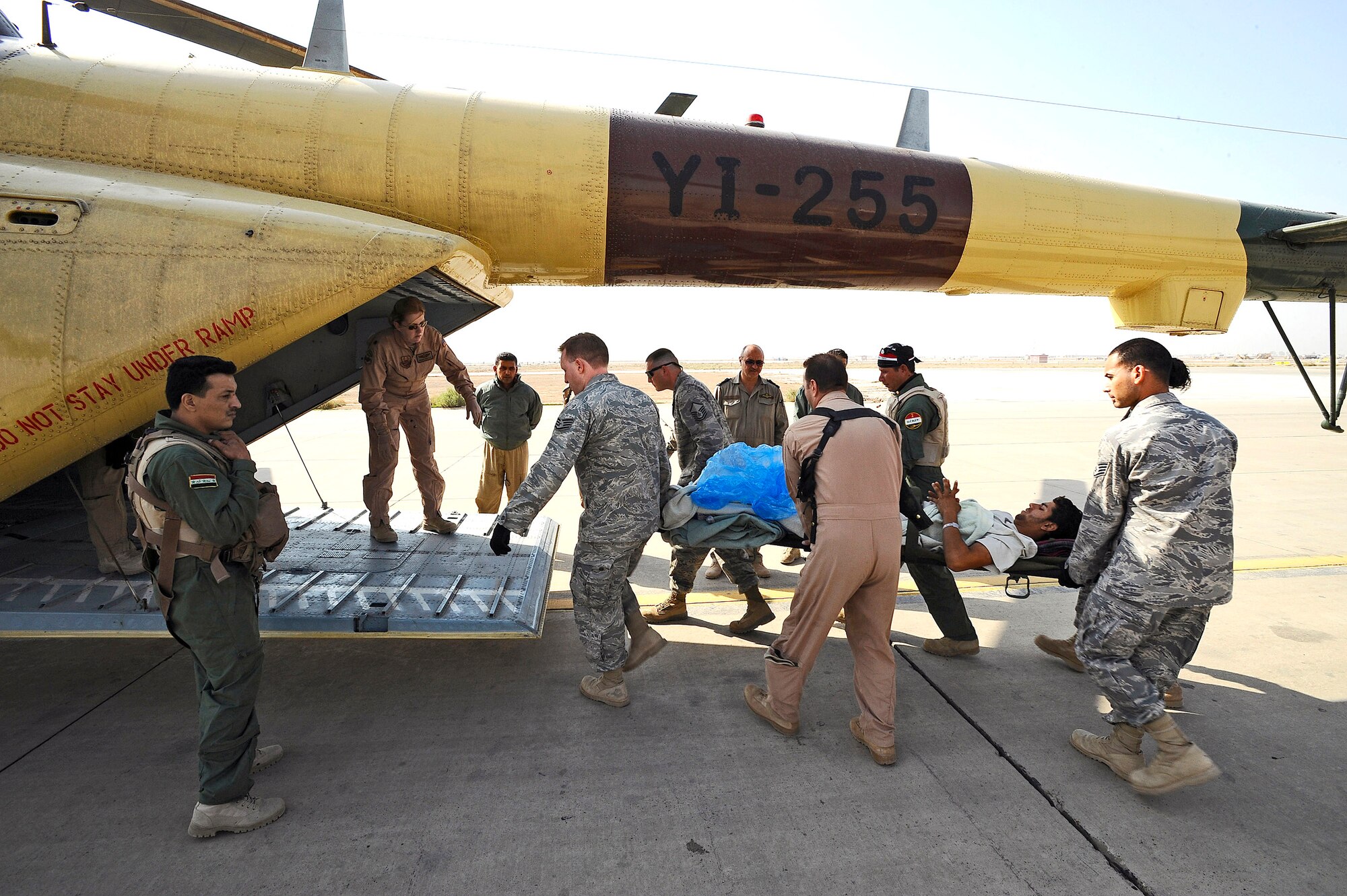 American and Iraqi airmen load a wounded Iraqi servicemember into an Iraqi air force Mi-17 Hip helicopter at Joint Base Balad, Iraq, Nov. 21. The Iraqi servicemember arrived at the Air Force Theater Hospital Nov. 16 with a gunshot wound to his leg. The Iraqi air force is developing its aeromedical evacuation capabilities to take on a greater role in transporting its patients. (U.S. Air Force photo/Airman 1st Class Jason Epley)