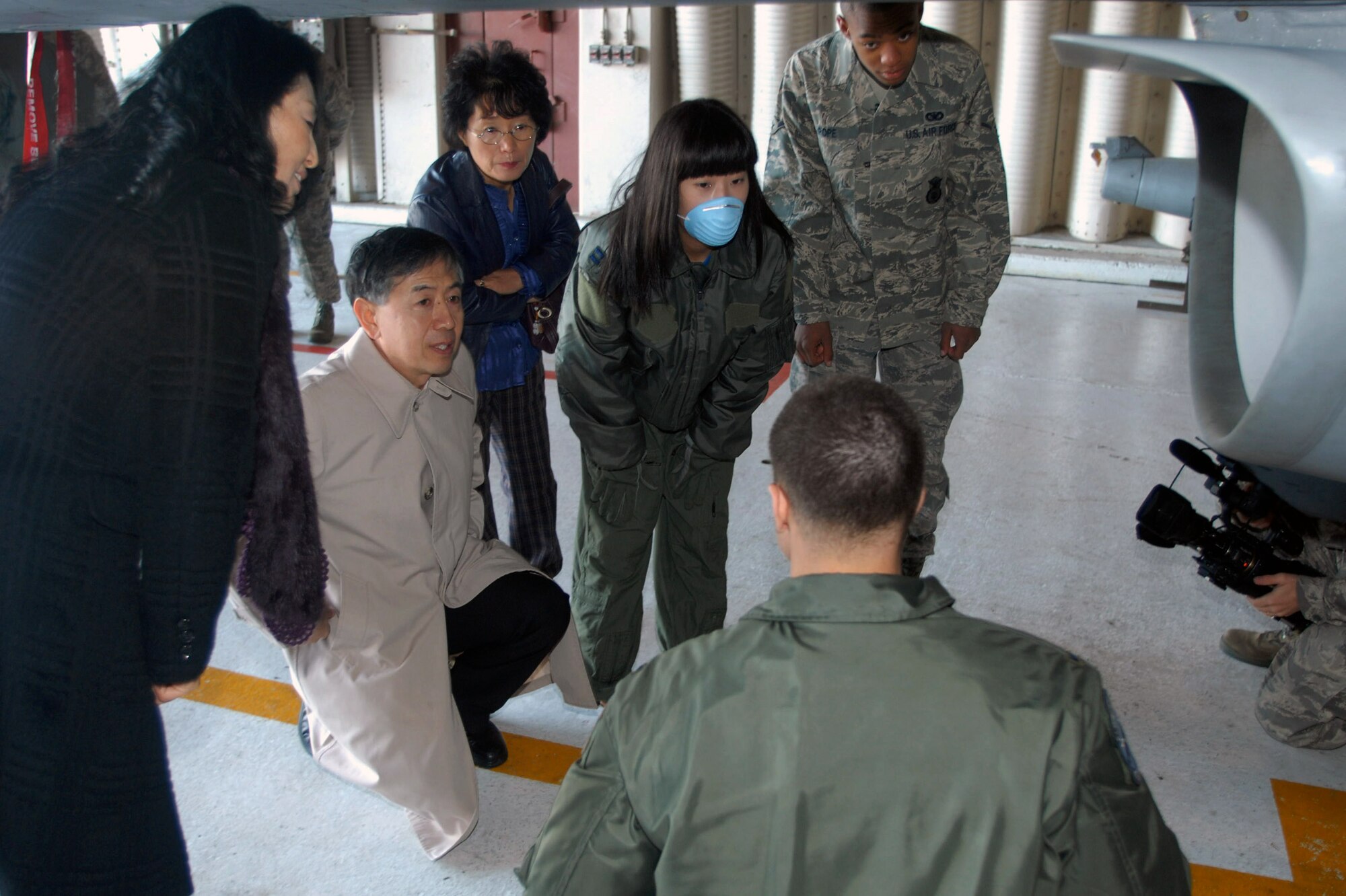 You Jin Pak and Airman Tamarias Pope are shown the exterior of an F-16 Fighting Falcon during Ms. Pak's Nov. 21 visit to Kunsan Air Base, South Korea. Airman Pope of the 8th Security Forces Squadron donated AB negative blood, which is rare among the South Korean population and specifically for Ms. Pak. The blood he donated ultimately saved her life. (U.S. Air Force photo/Senior Airman Gustavo Gonzalez) 
