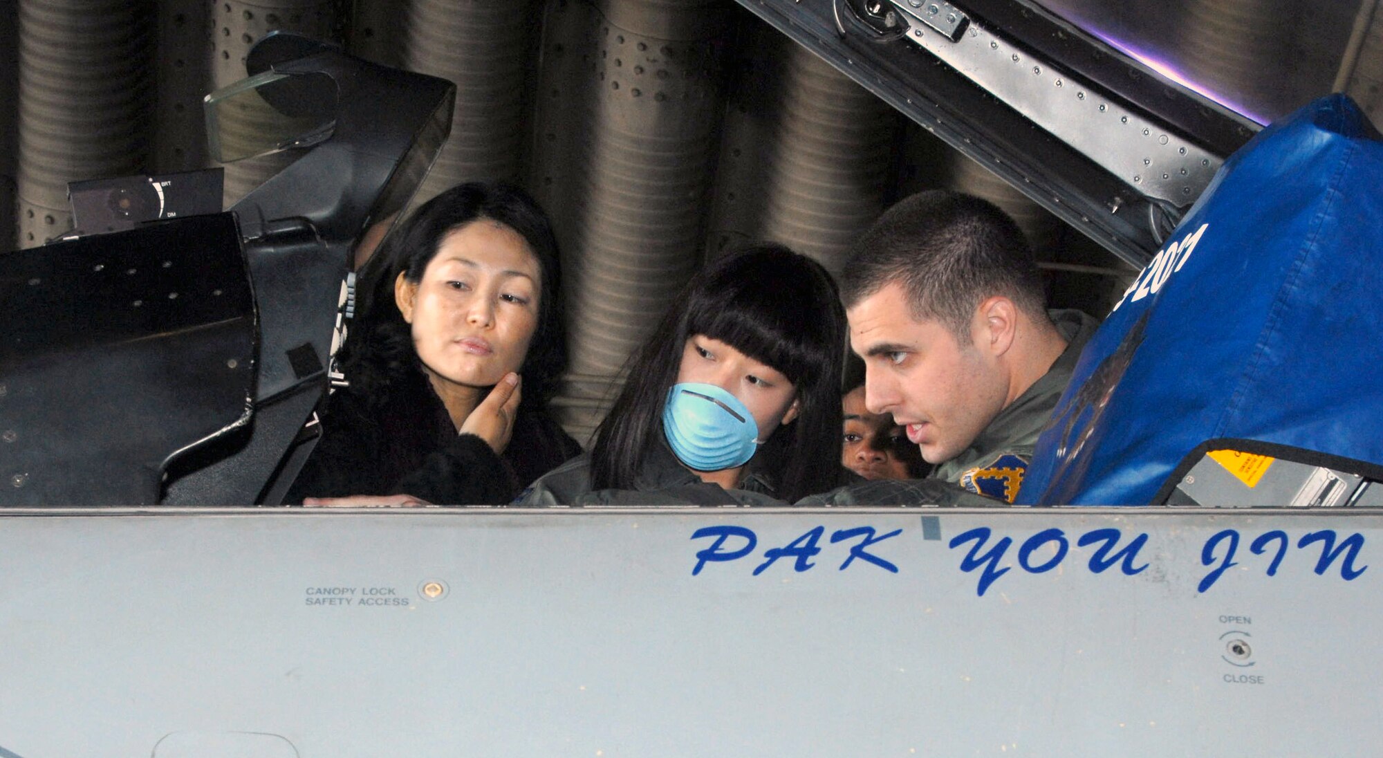 First Lt. Brad Brizek shows You Jin Pak the inteirior of an F-16 Fighting Falcon Nov. 21 at Kunsan Air Base, South Korea. An 8th Security Forces Squadron member donated AB negative blood, which is rare among the South Korean population and specifically for Ms. Pak. The blood he donated ultimately saved her life. Lieutenant Brizek is assigned to the 35th Fighter Squadron. (U.S. Air Force photo/Senior Airman Gustavo Gonzalez) 
