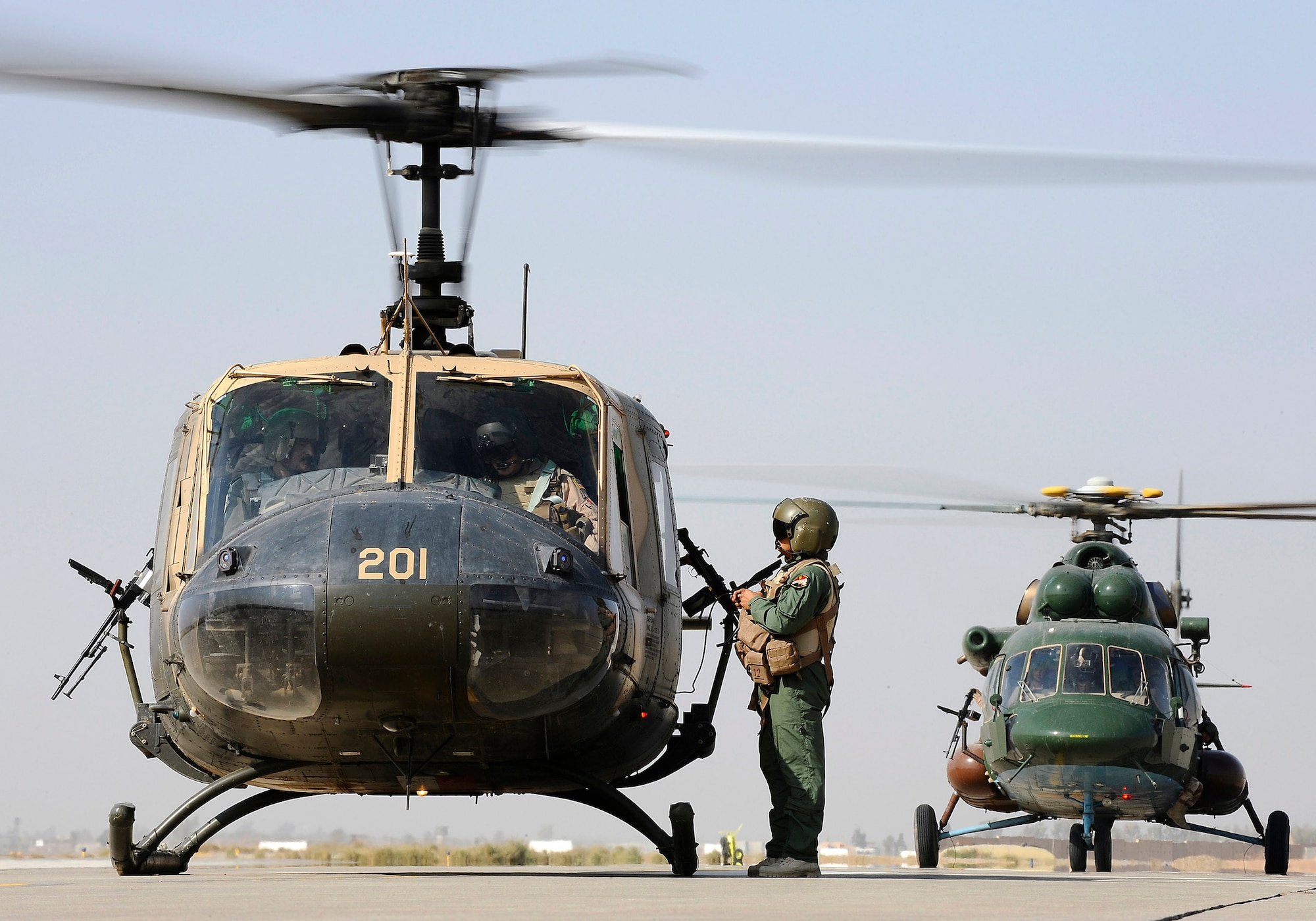 An Iraqi UH-1H Iroquois "Huey" helicopter and an Iraqi Mi-17 Hip helicopter prepare to transport a wounded Iraqi servicemember from Joint Base Balad, Iraq, to Forward Operating Base Gabe in Baqubah, Iraq, Nov. 21. The servicemember arrived at the Air Force Theater Hospital  at Joint Base Balad Nov. 16 with a gunshot wound to his leg. The Iraqi air force is developing its aeromedical evacuation capabilities to take on a greater role in transporting its patients. (U.S. Air Force photo/Airman 1st Class Jason Epley)