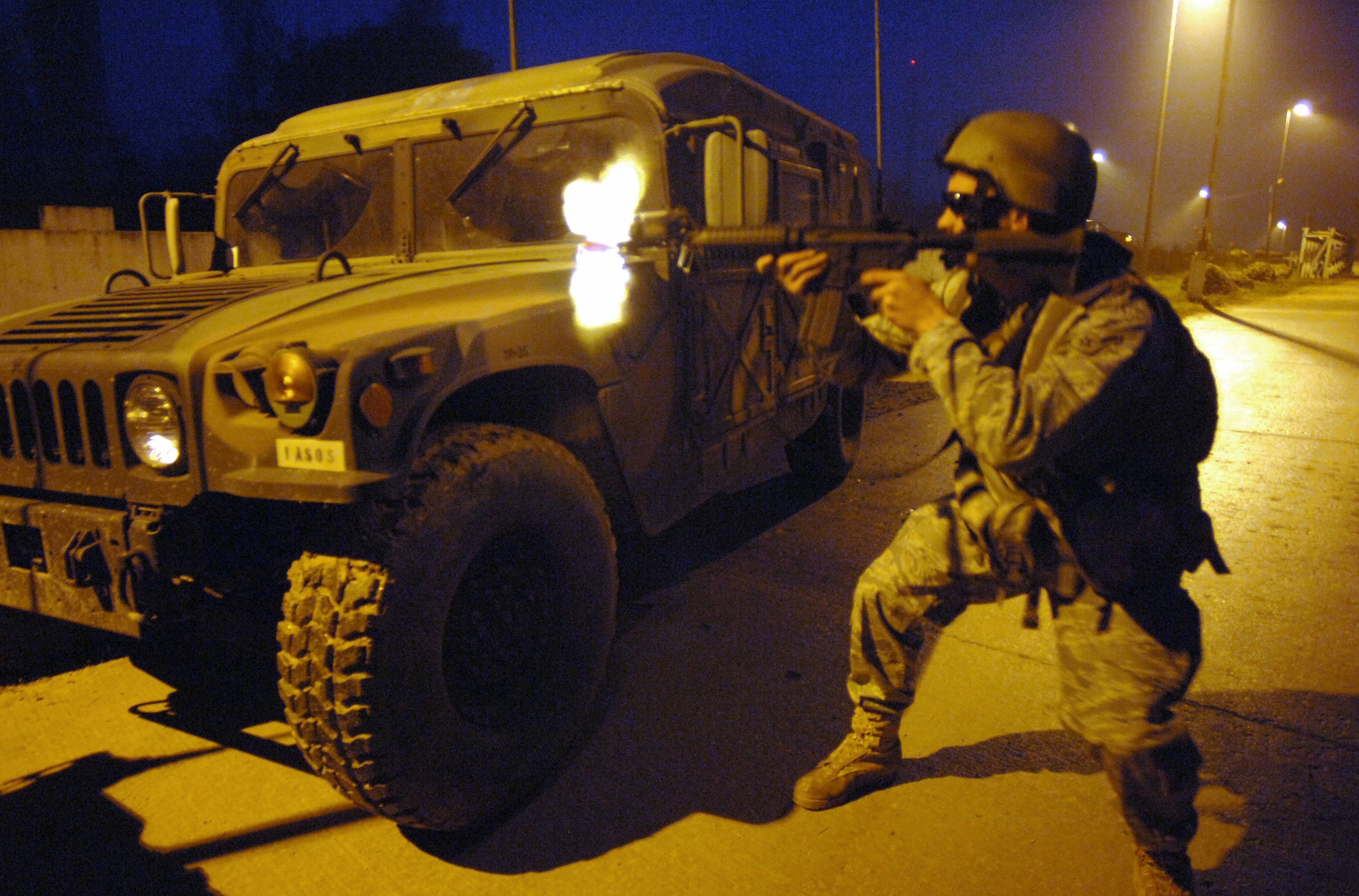 Airman Bryan Cravill provides cover fire for Soldiers and Airmen escaping "hostile action" during Exercise Allied Strike II Nov. 6 at Hohenfels U.S. Army Garrison, Germany. The urban warfare scenario is part of a week-long joint terminal air controller-centric exercise designed to prepare U.S. Air Forces Europe and NATO JTACs for Operation Iraqi Freedom and Operation Enduring Freedom. Airmen Cravill is a tactical air control party member assigned to the 2nd Air Support Operations Squadron in Vilsek, Germany.(Defense Department photo/Master Sgt. Scott Wagers) 
