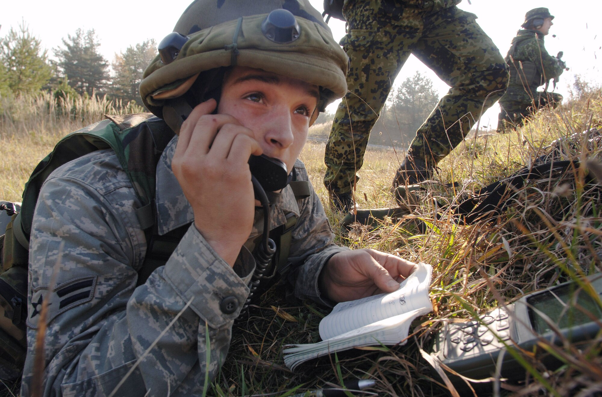 Airman 1st Class Michael Kelly assists Danish soldiers by relaying the location of a target for an F-15E Strike Eagle pilot during a close-air-support scenario for Exercise Allied Strike II Nov. at Grafenwoehr U.S. Army Garrison, Germany. The week-long joint terminal air controller-centric exercise involves 90 U.S. and coalition personnel with close-air-support assets from five U.S. and coalition air wings and is designed to prepare U.S. Air Forces Europe and NATO JTACs for Operation Iraqi Freedom and Operation Enduring Freedom. Airman Kelley is a radio operator maintainer and driver assigned to 1st Air Support Operations Squadron in Wiesbaden, Germany. (Defense Department photo/Master Sgt. Scott Wagers) 

