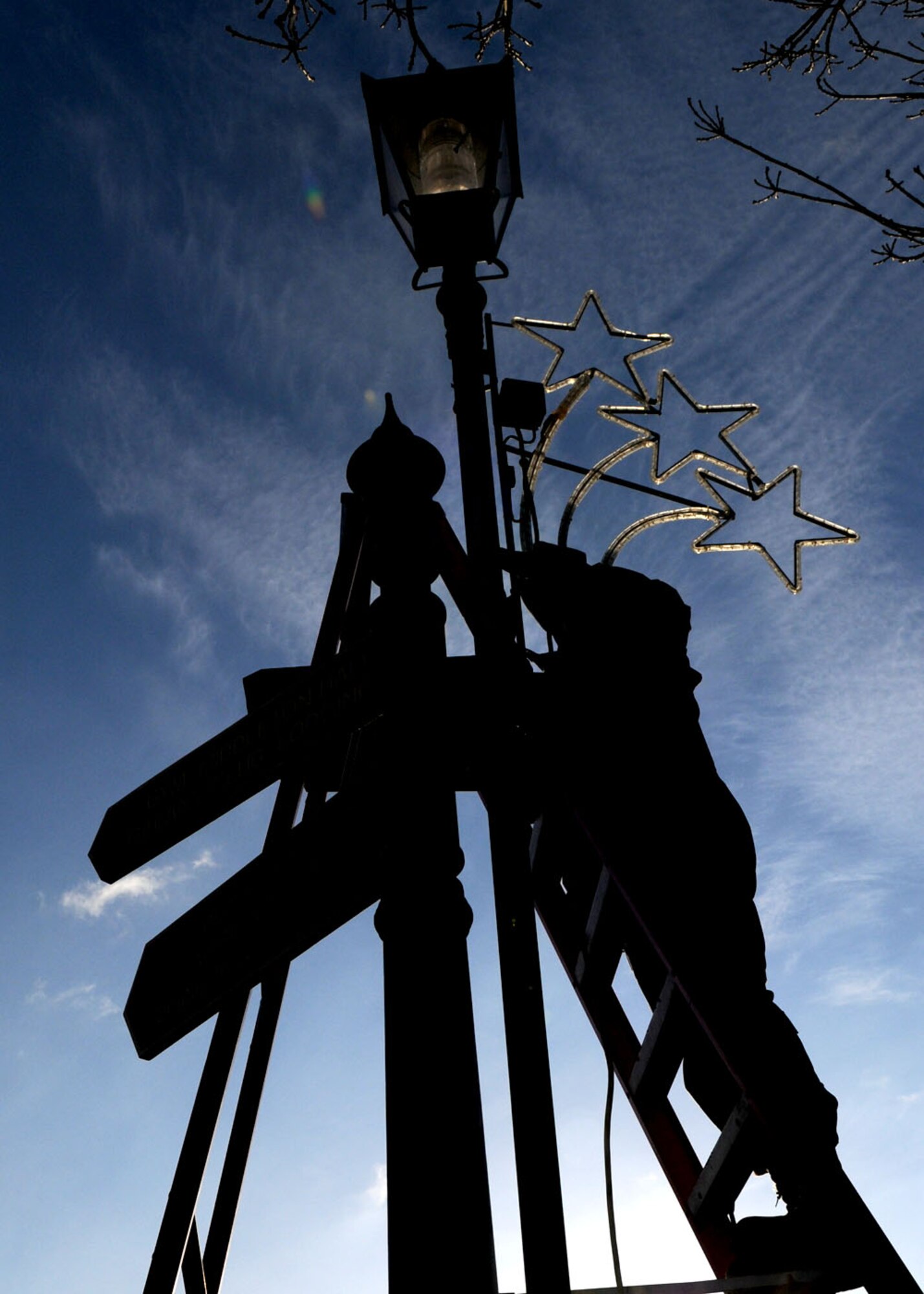 Staff Sgt. Rafeeq Jordan, an electrical systems craftsman from the 100th Civil Engineer Squadron, attaches star-shaped holiday lighting to streetlights throughout RAF Mildenhall Nov. 18, 2008 in preparation for the holiday season at RAF Mildenhall, England. After all holiday preparations are complete, there will be a Christmas tree lighting ceremony Dec. 4 at 4:30 p.m., adjacent to building 422 (opposite Mickey’s Tea Bar). (U.S. Air Force photo by Staff Sgt. Jerry Fleshman)