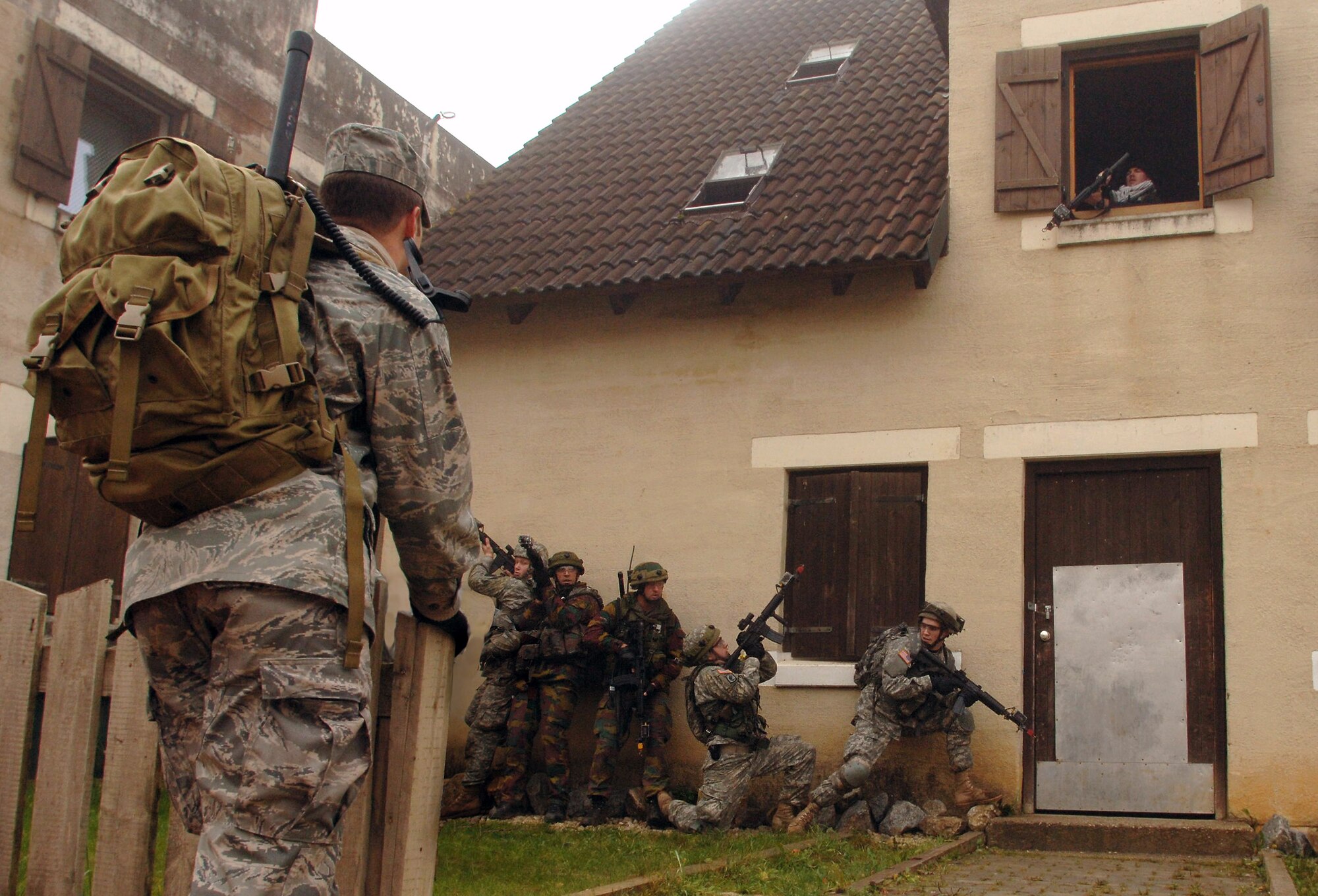 Staff Sgt. Jason Tonkinson evaluates an urban warfare scenario involving U.S. and Belgian forces during Exercise Allied Strike II at Hohenfels Army Garrison, Germany. 
The U.S. Ssoldiers with the 173rd Air Brigade Combat Team, 191 Cavalry, provided security for Belgian forward air controllers during a joint terminal air controller-centric exercise designed to prepare U.S. Air Forces Europe and NATO JTACs for Operation Iraqi Freedom and Operation Enduring Freedom. Sergeant Tonkinson is a JTAC instructor assigned to the 8th Air Support Operations Squadron at Aviano Air Base, Italy. (Defense Department photo/Master Sgt. Scott Wagers)
