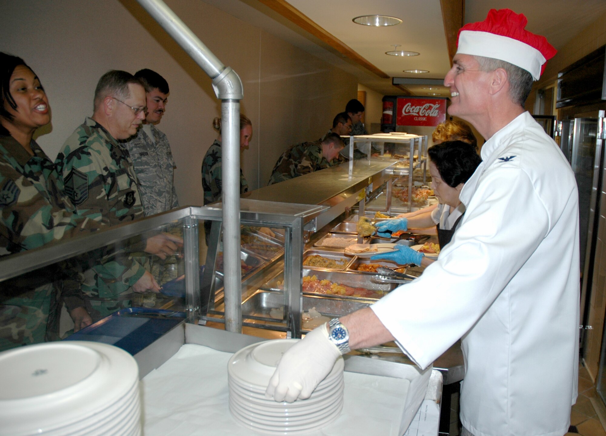 Colonel Steven Chapman (right), 919th Special Operations Wing commander, takes time out on the unit training assembly weekend to serve holiday meals to members of Duke Field . He took the opportunity to thank reservists for their service and commitment.  Joining Colonel Chapman on the serving line were Chief Master Sgt. Rocky Hart, outgoing 919th SOW command chief, Master Sgt. Steve Morgan, 919th SOW first sergeant, and Col. James Brock, 919th Maintenance Group commander. (U.S. Air Force Photo by Senior Airman Jon McCallum)